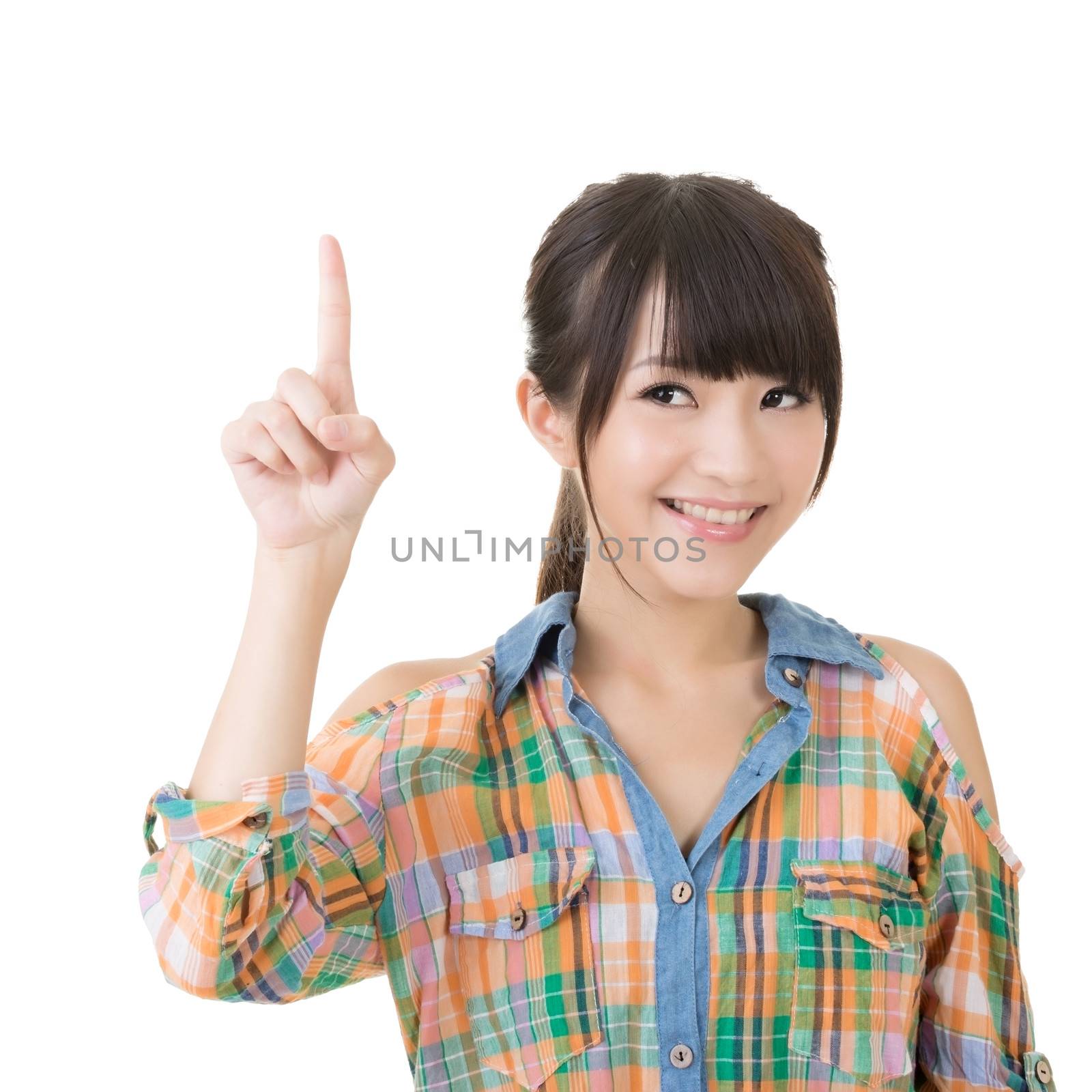 Young pretty asian woman pointing up. Isolated on the white background.