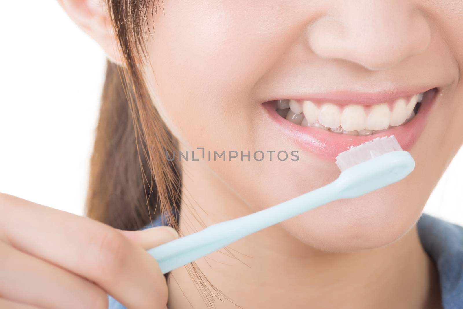Closeup shot of woman brushing teeth.