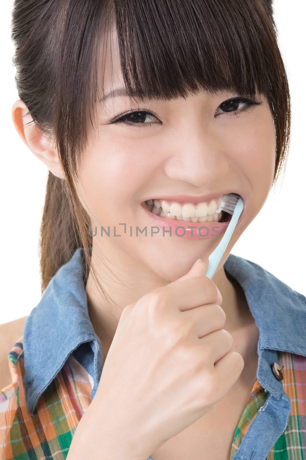Closeup portrait of woman brushing teeth by elwynn