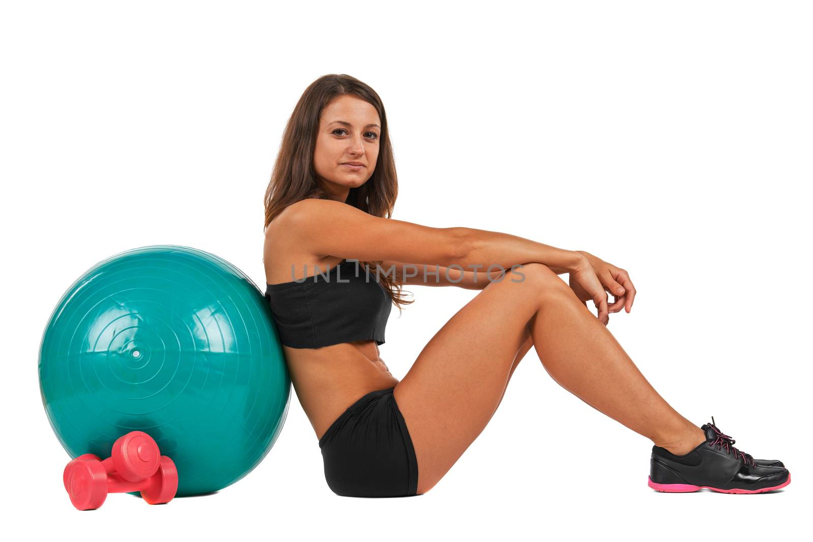 Young woman with sport gymnastic ball in the studio