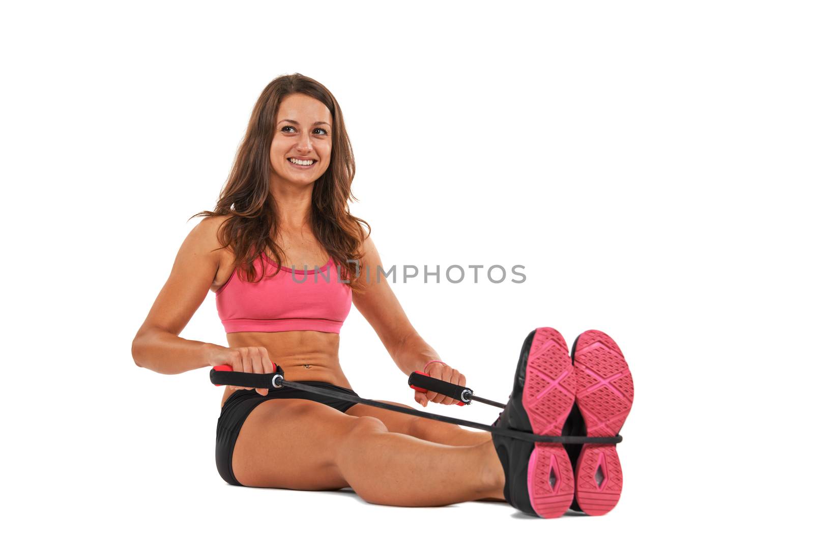 Young woman in the studio streching and working out