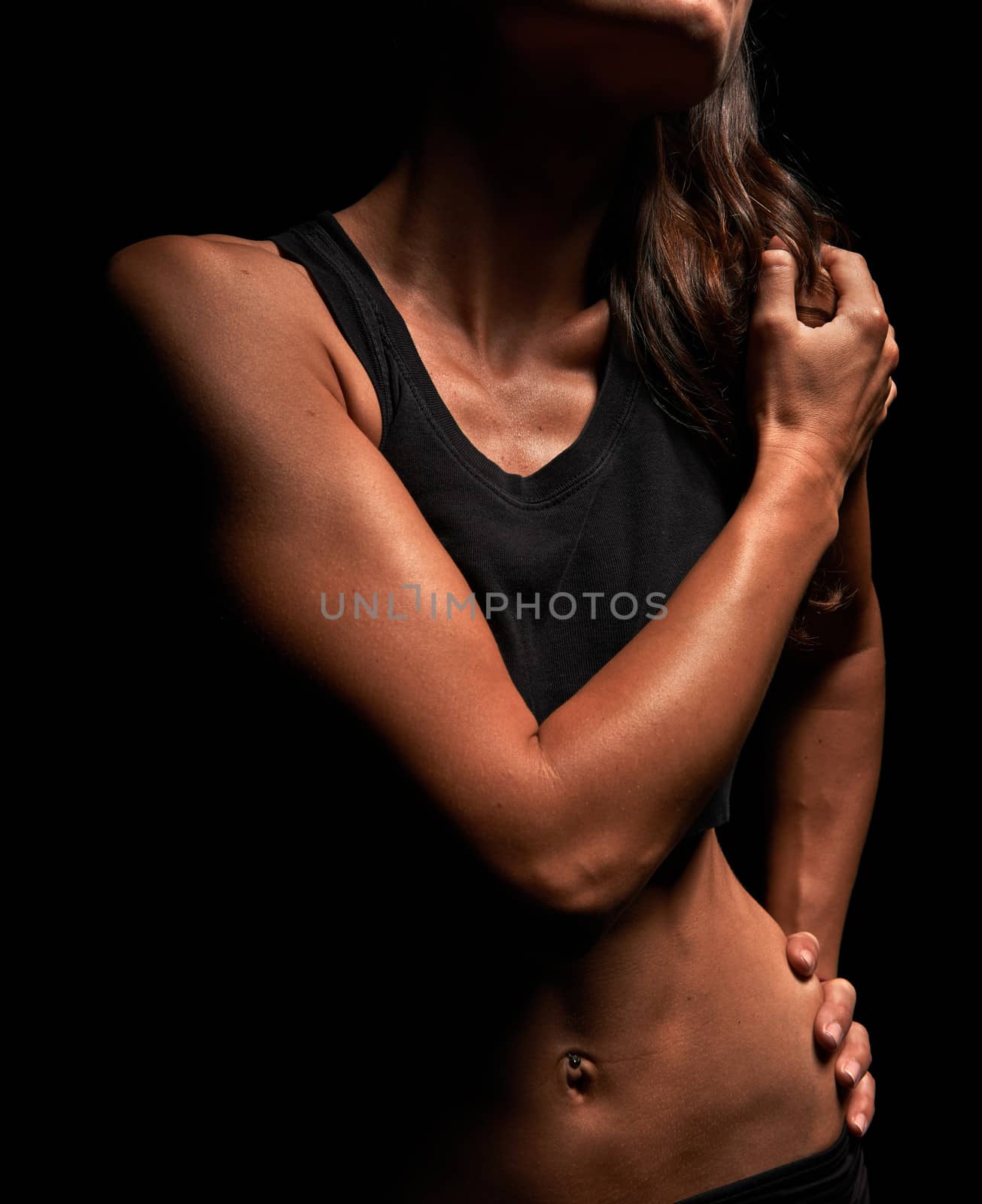 Beautiful muscular fitness instructor in a studio