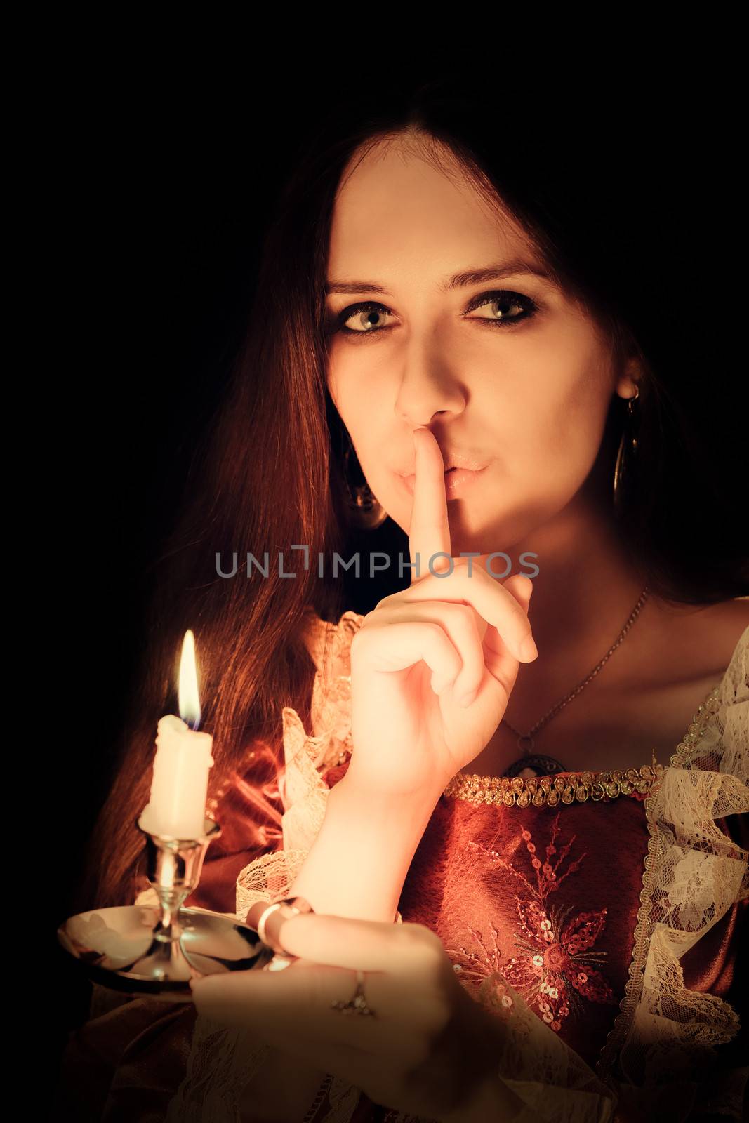 Girl holding a candle in a vintage dress.