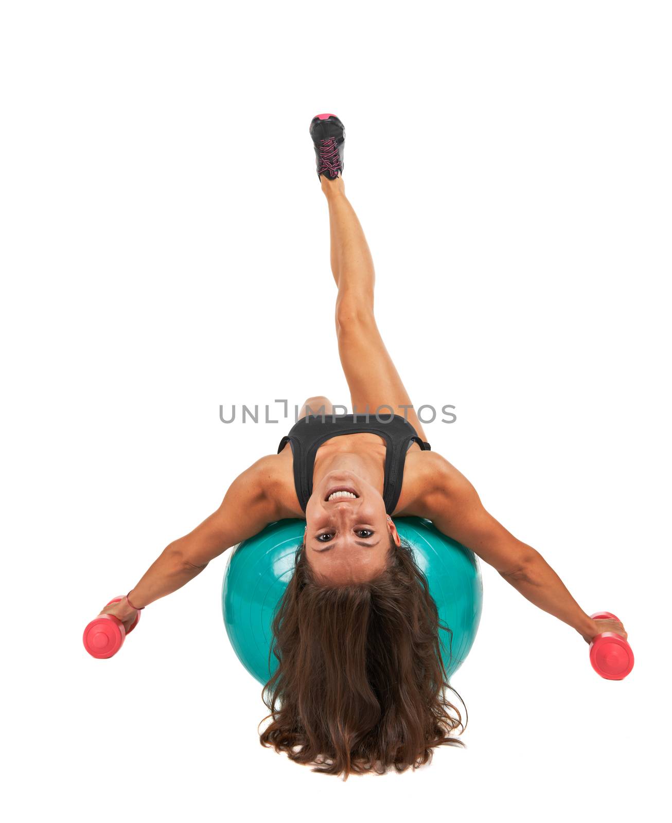 Young woman in the studio with weights and fitness ball