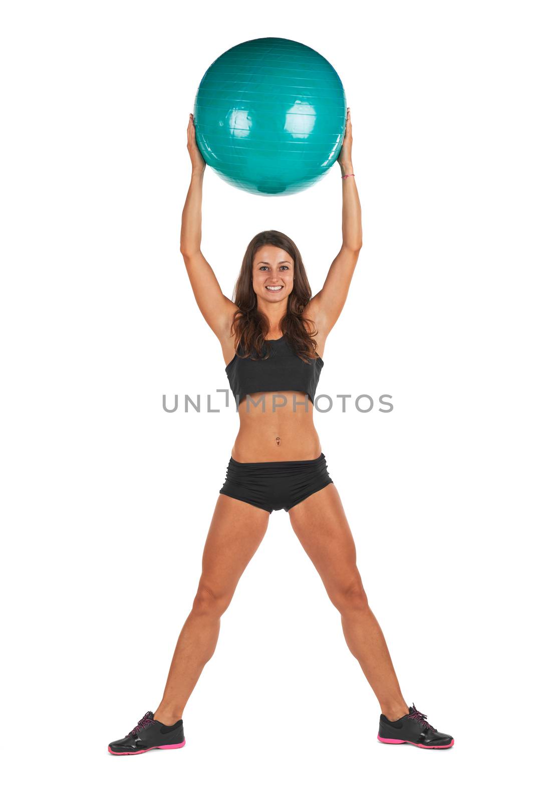 Young woman in the studio with fitness ball against white background
