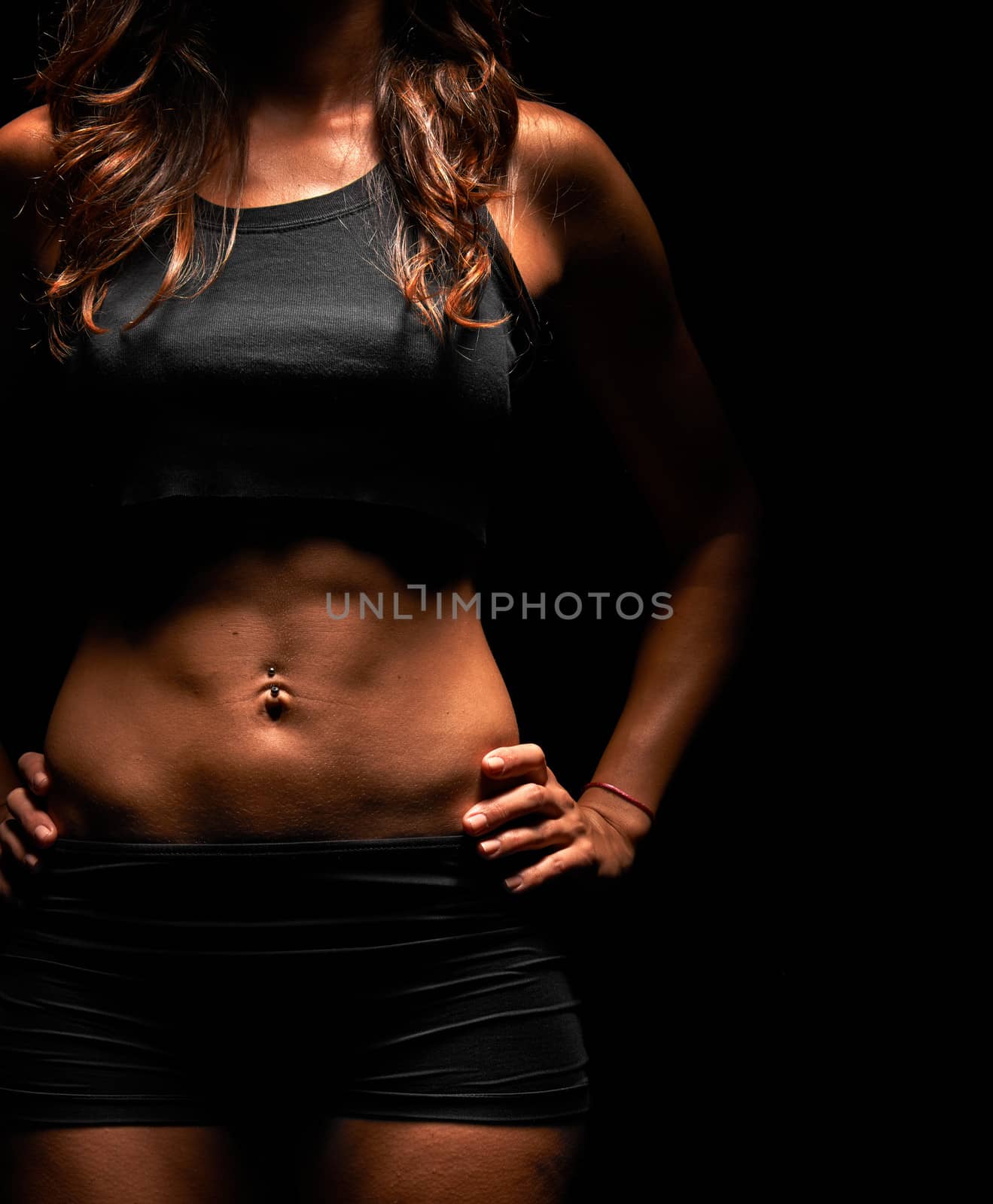 Beautiful muscular fitness instructor in a studio