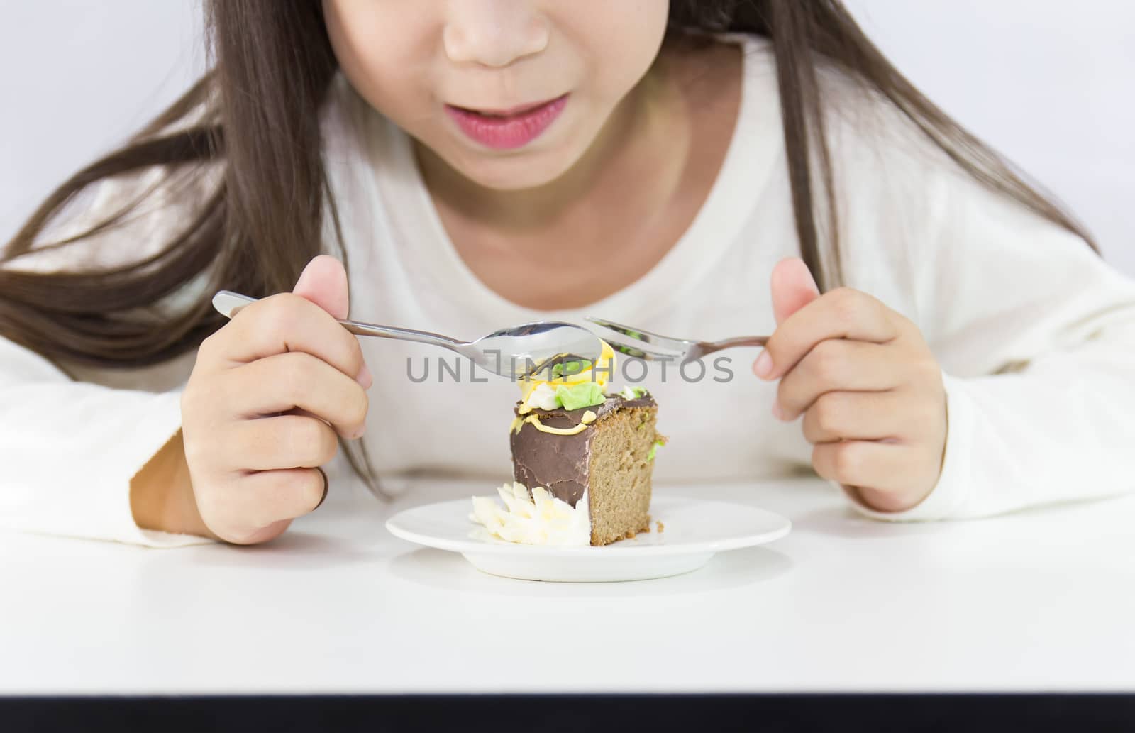 Girl eating cake.  on white background