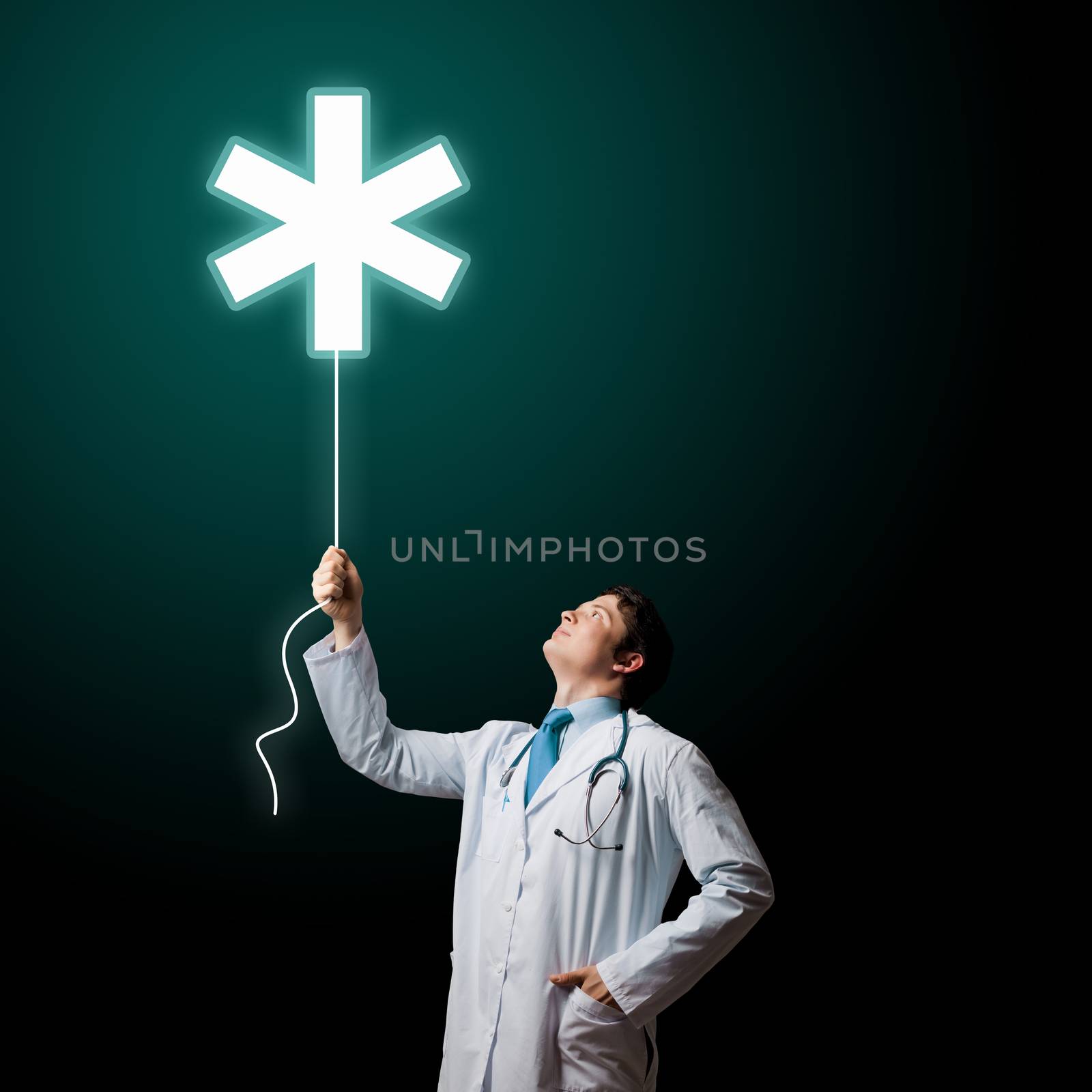 Young male doctor holding balloon with medical sign