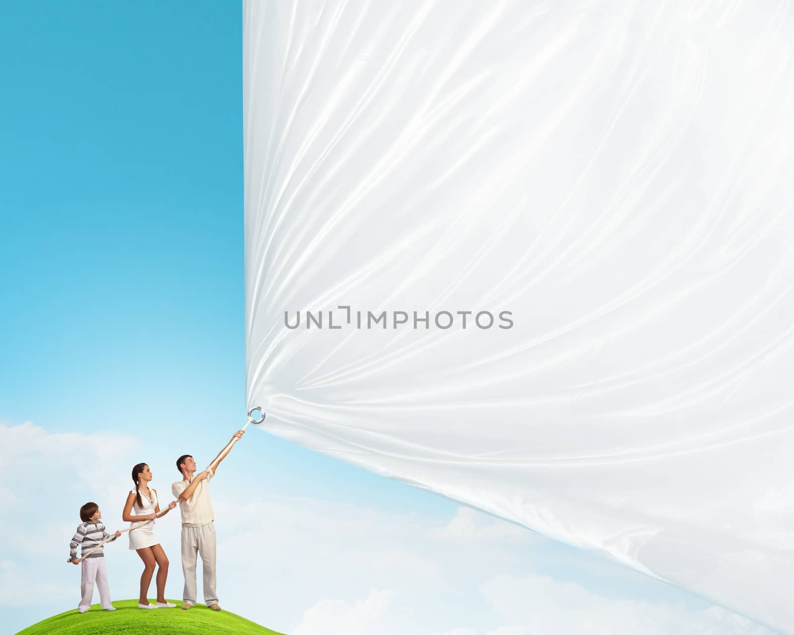 Father and son pulling blank banner. Place for text