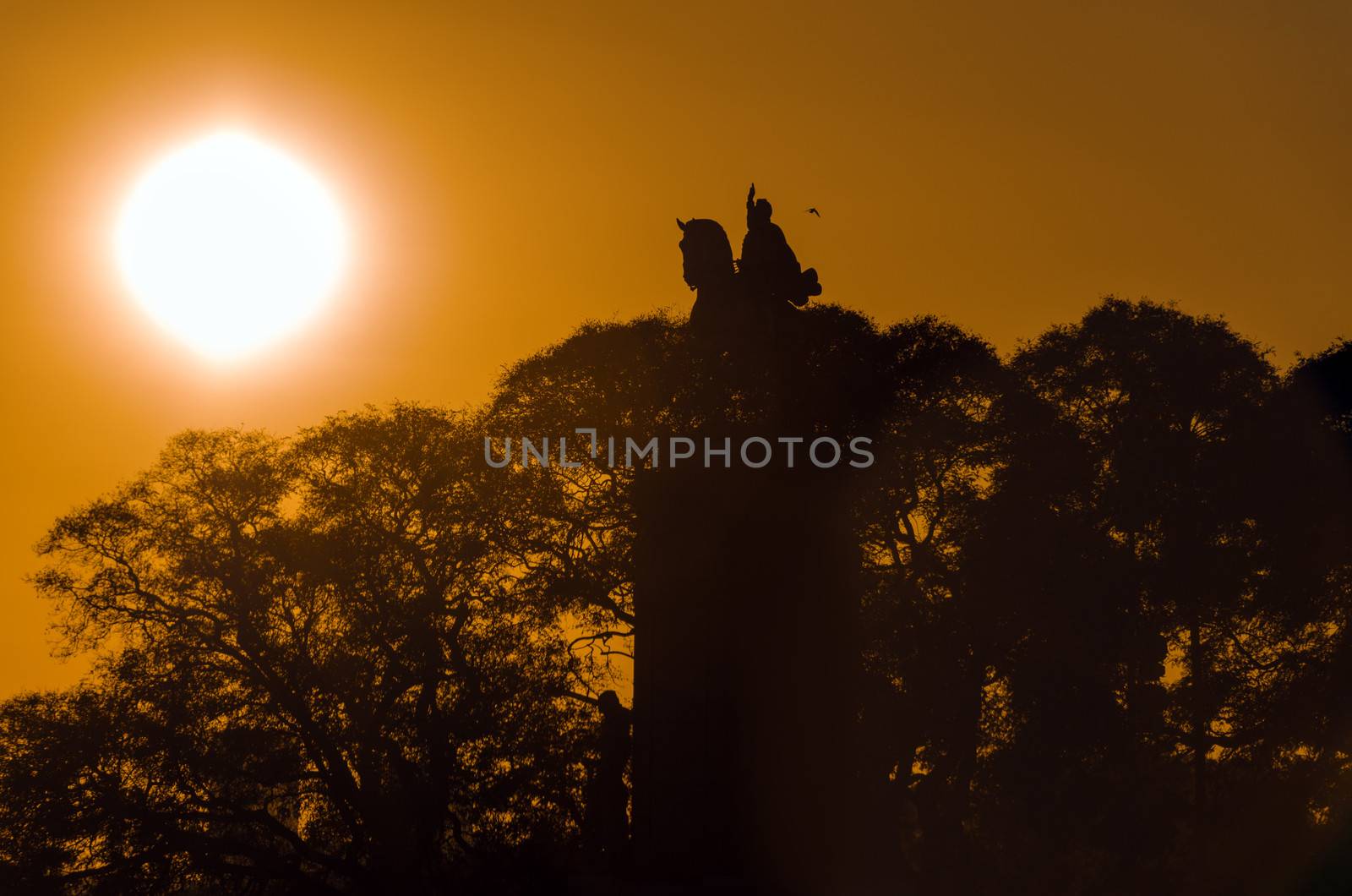 The sun rising of a statue in the Recoleta neighborhood of Buenos Aires, Argentina