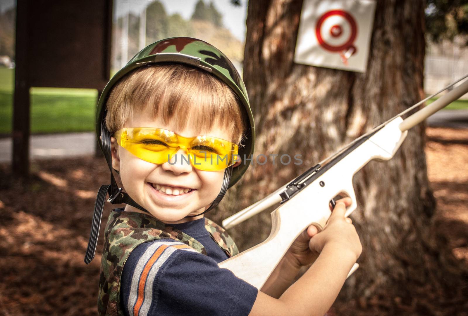 Boy playing with toy crossbow gun by 805promo