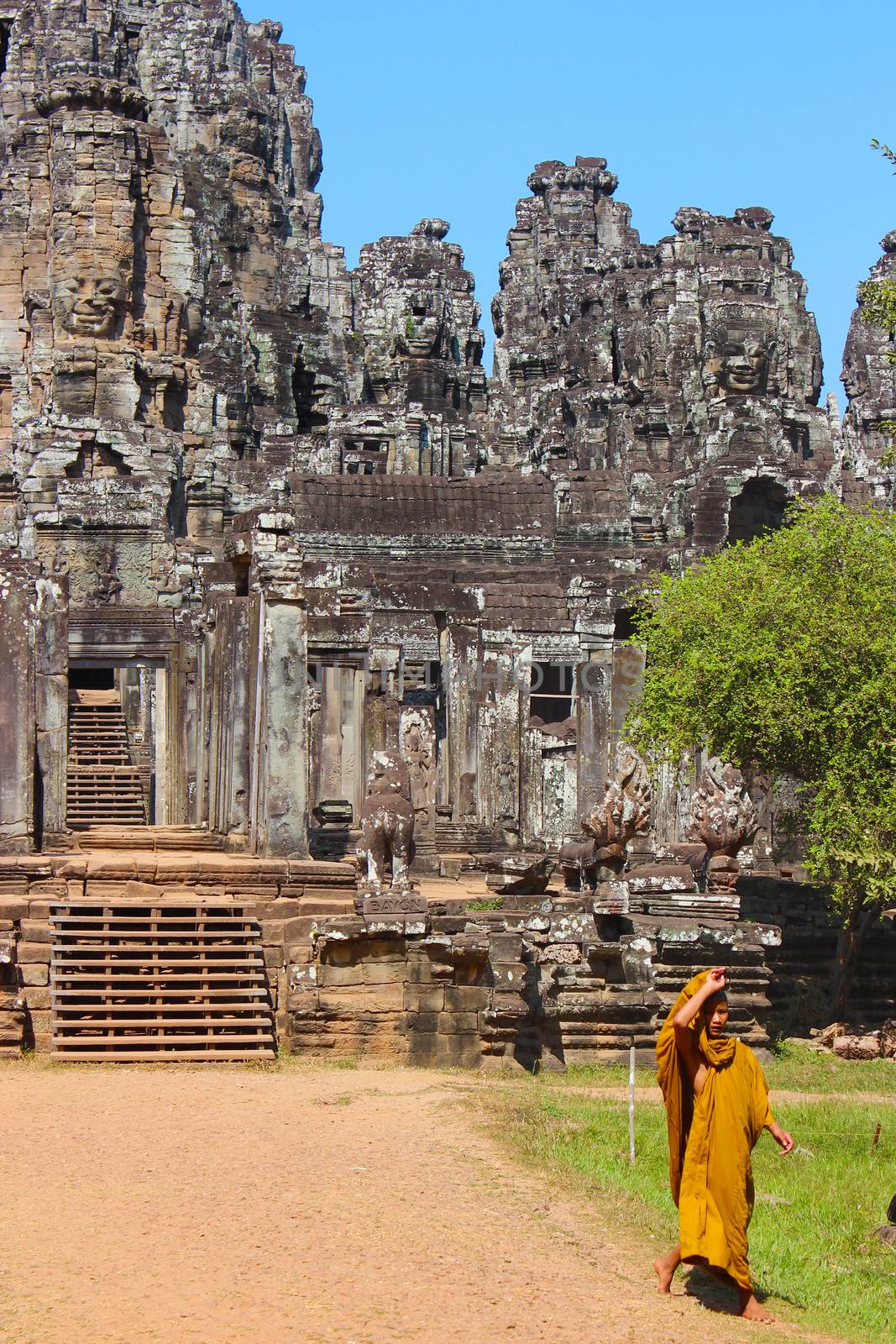 A young monk at the entrance of Bayon in Angkor, Cambodia