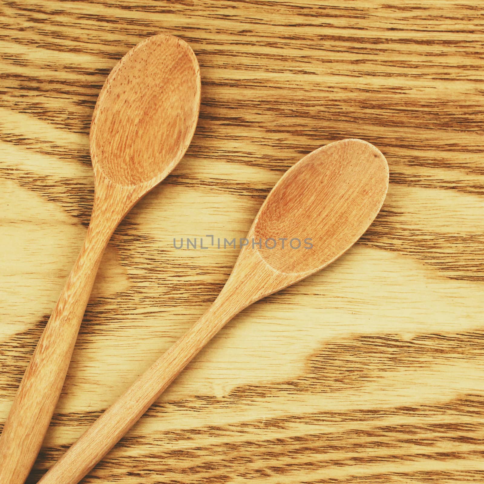 Two wooden spoons on table with retro filter effect by nuchylee