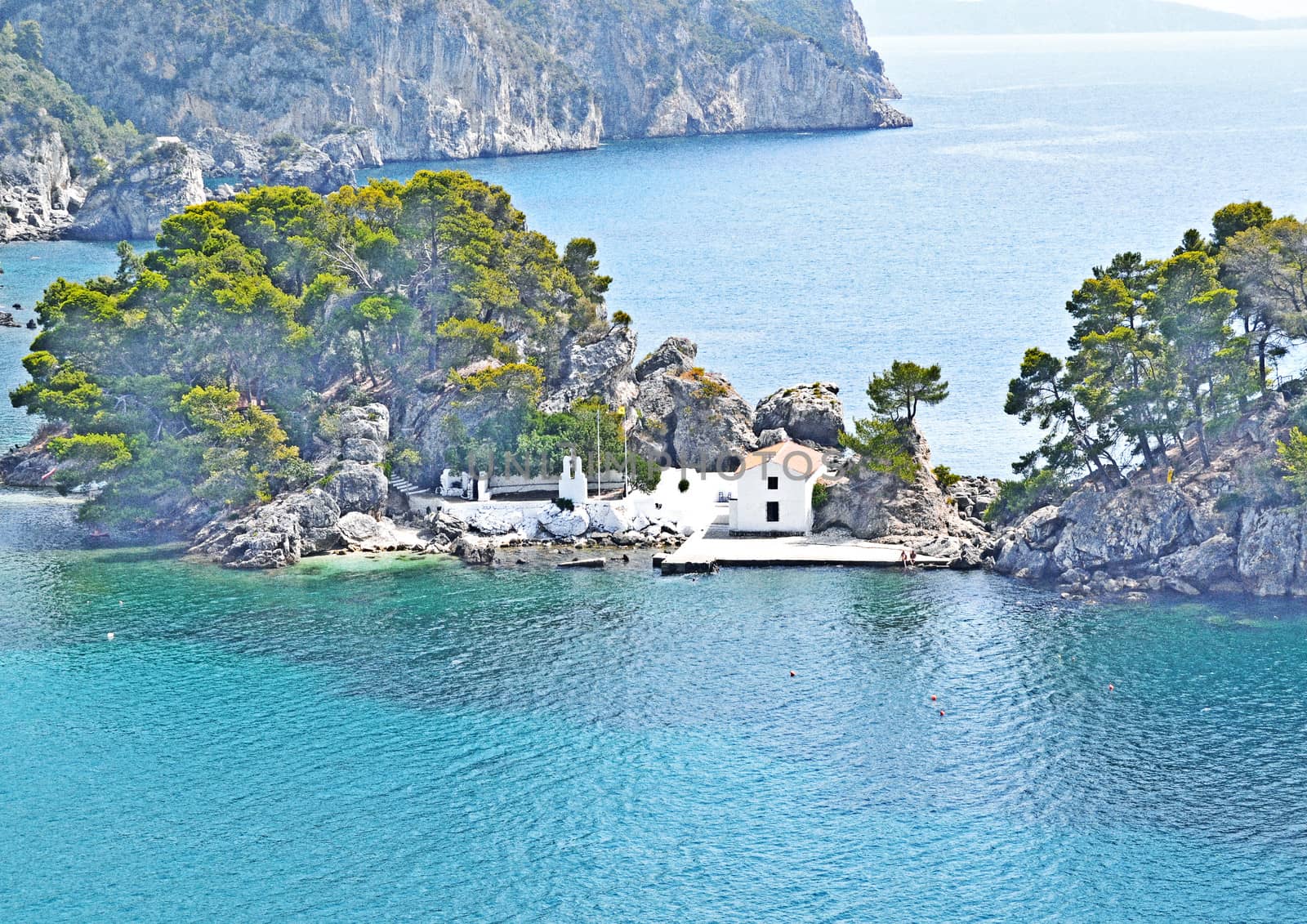 The bay coast with boats and houses under the bright sky