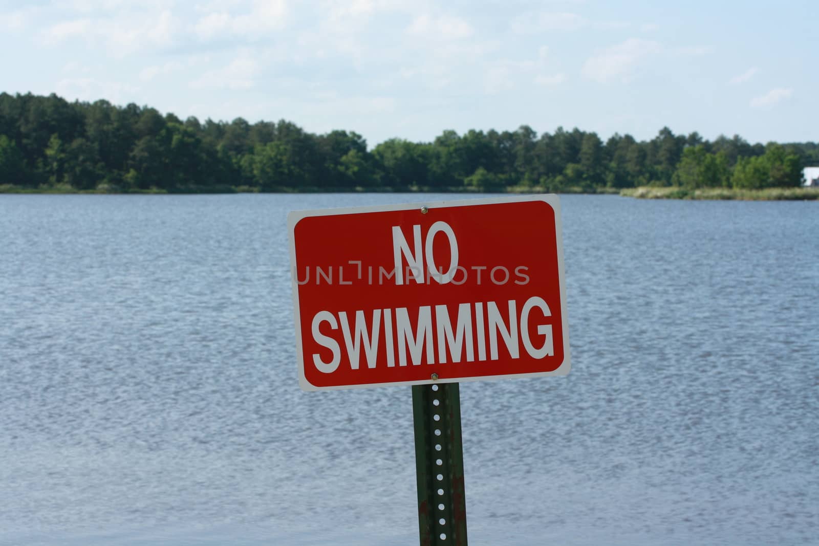 Red sign warning against swimming