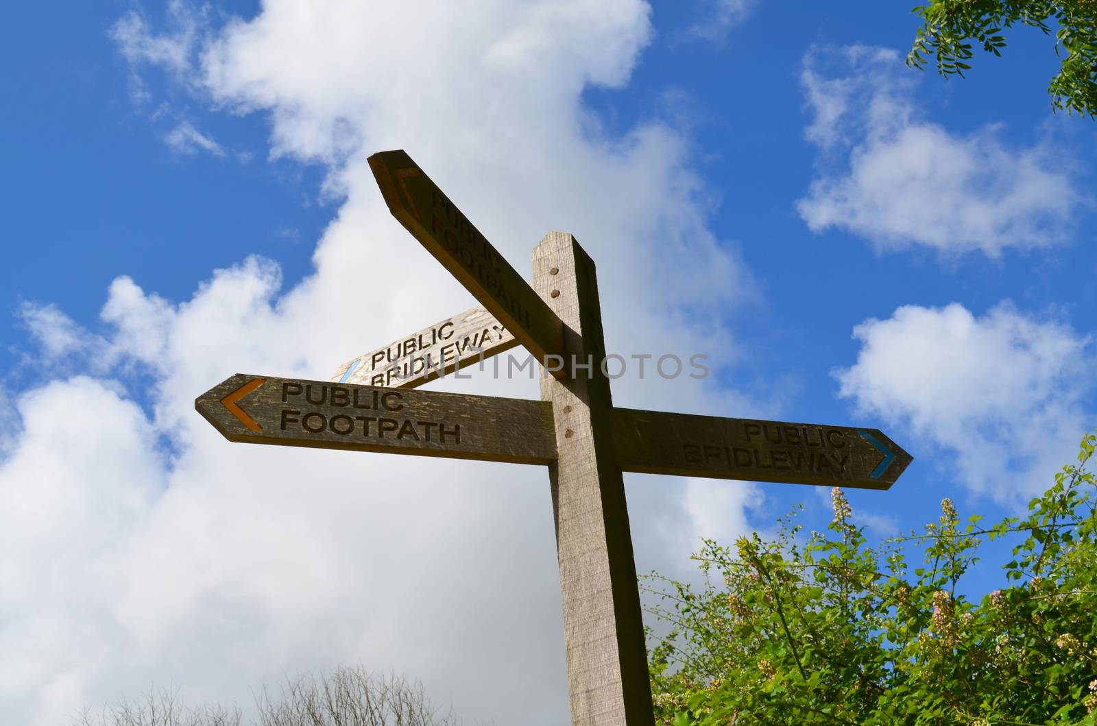 A wooden signpost informing of public and bridleway routes. Shot taken in the Summer of 2013 along the South Downs Way, Sussex,England.