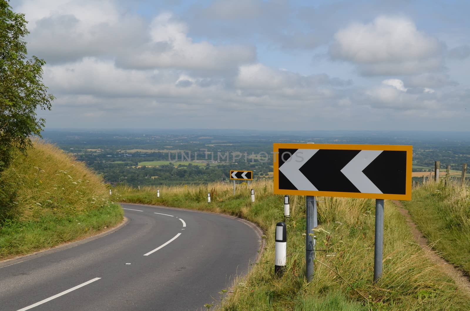 Warning signs placed at a tight left hand bend on the top of Ditchling Beacon, Sussex,England.