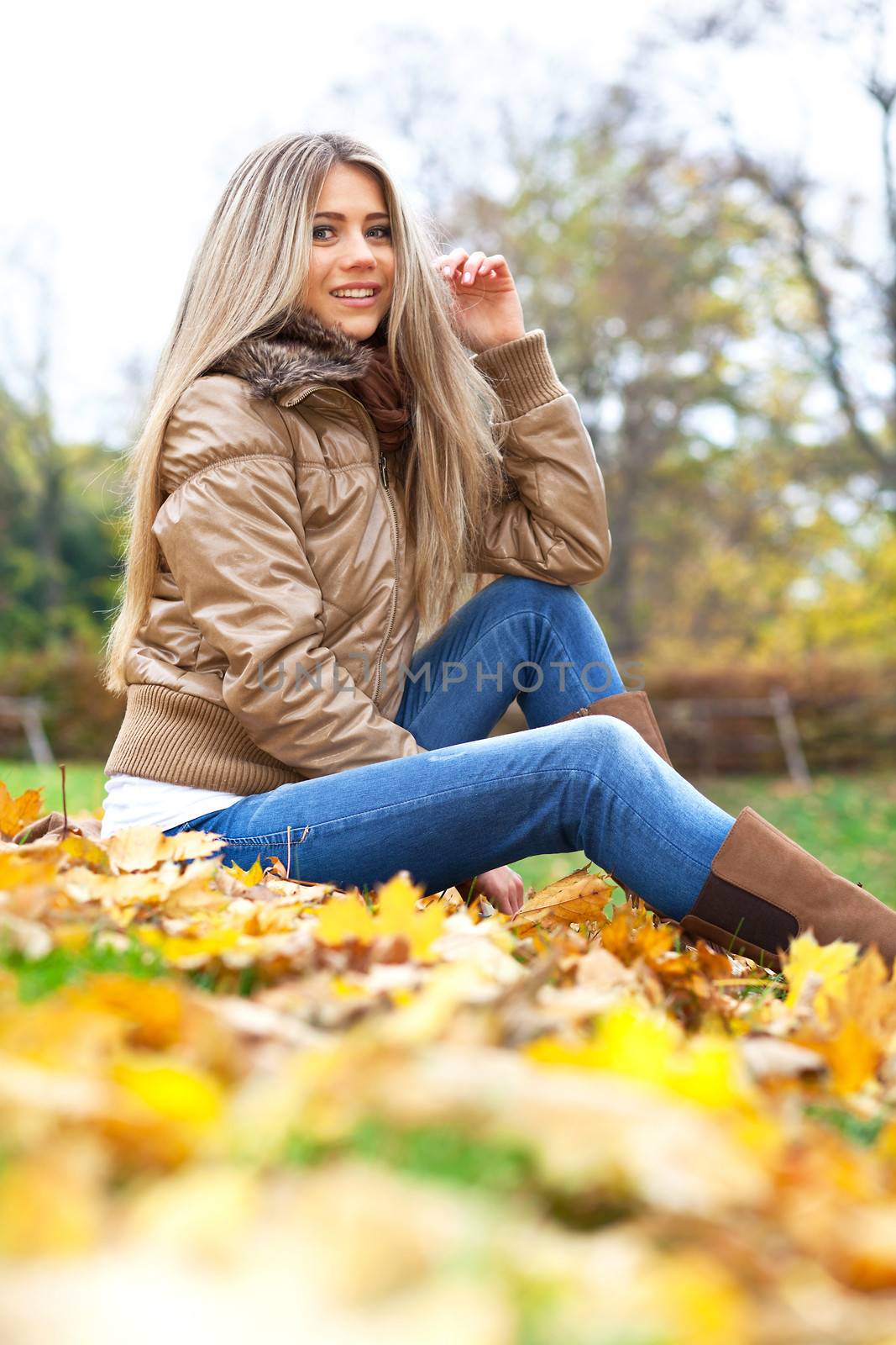 Young blond woman sitting in a park by TristanBM