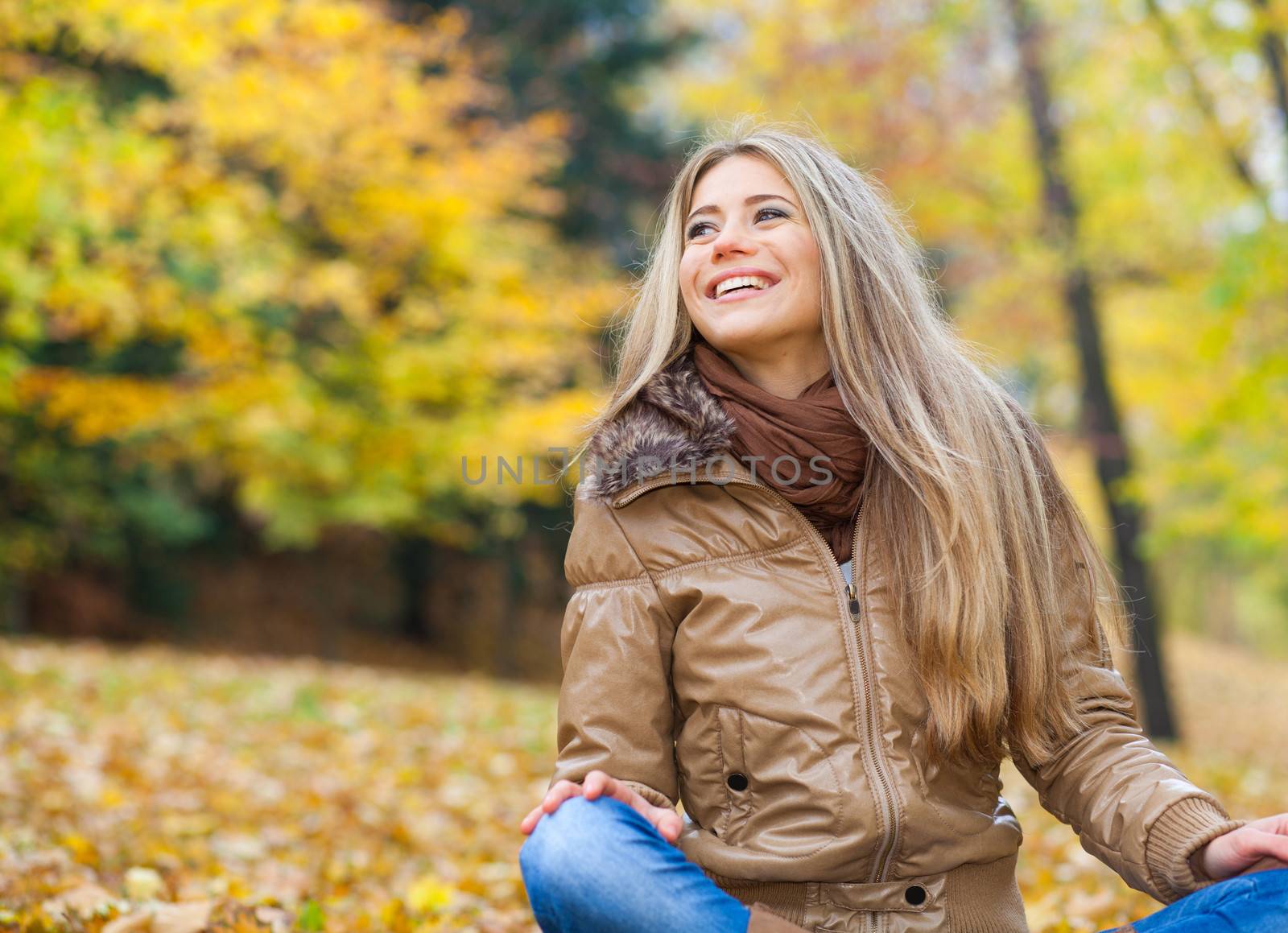Young blond woman in a park in autumn