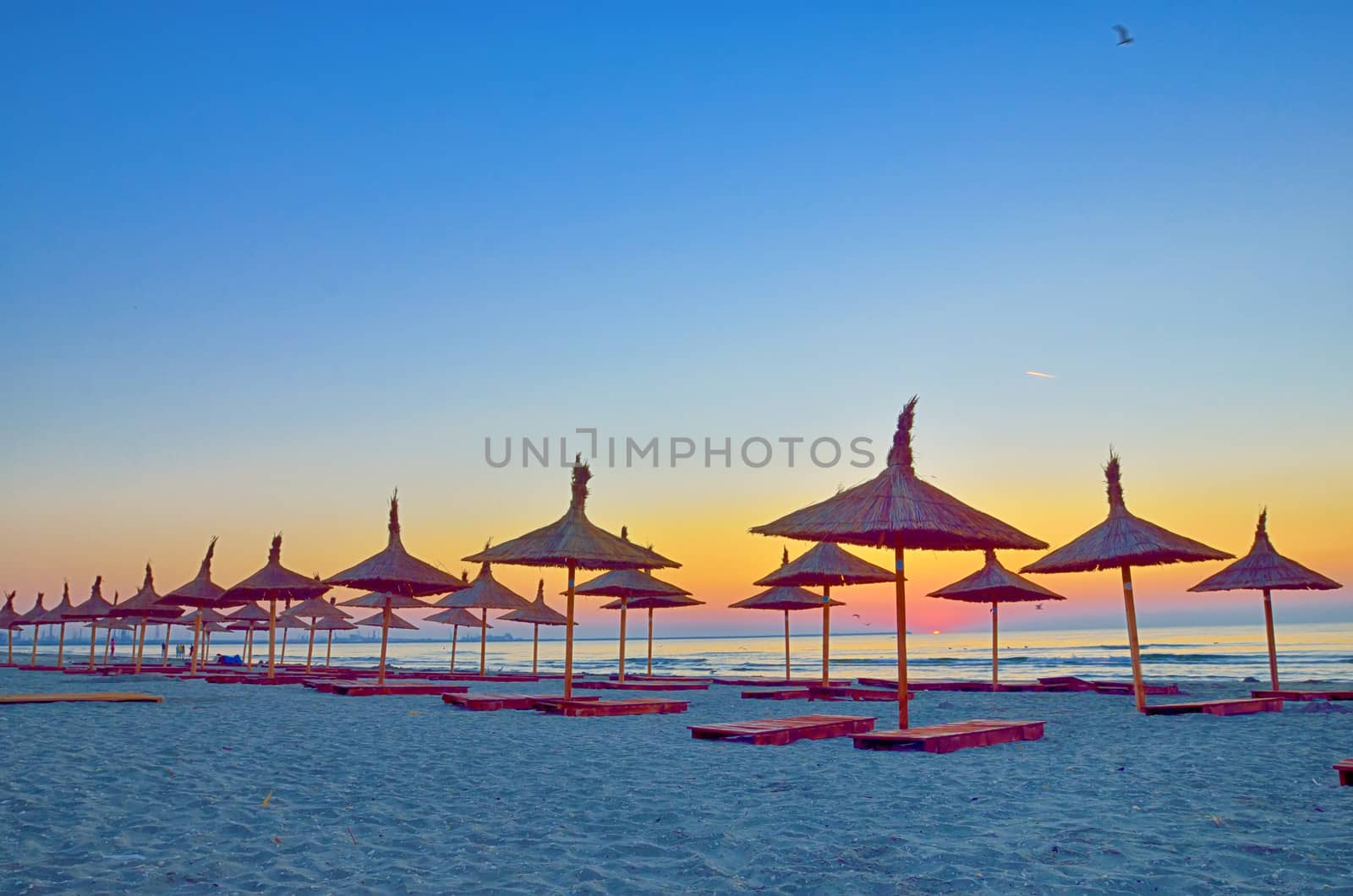 Sunrise under parasol on the Black Sea  beach