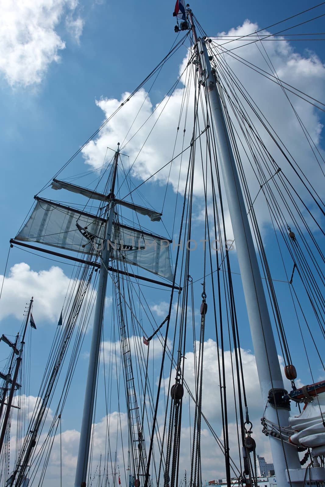 Sailing masts of traditional vintage wooden tallships sky background                               