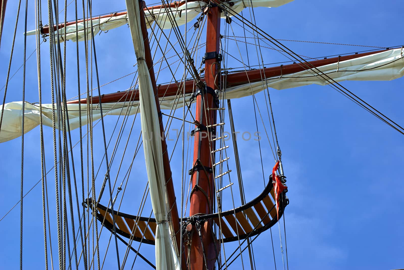 Sailing masts of traditional vintage wooden tallships sky background