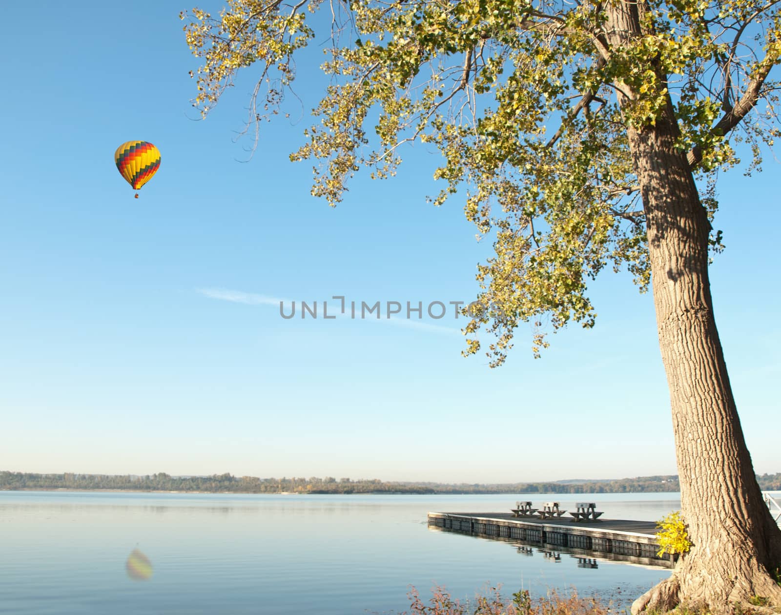 hot air balloon over lake by debramillet