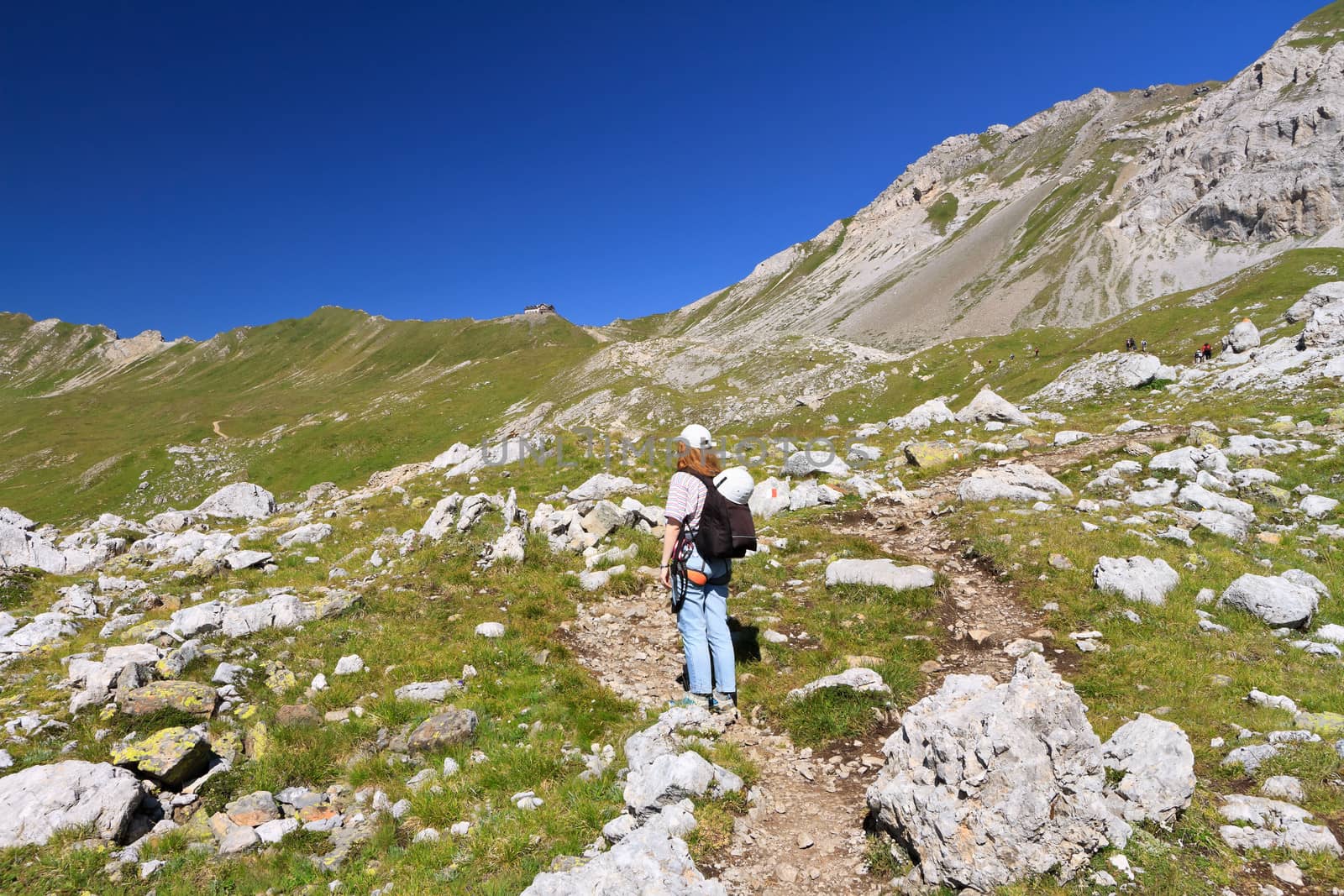 hiker walks on a path in Italian Dolomites