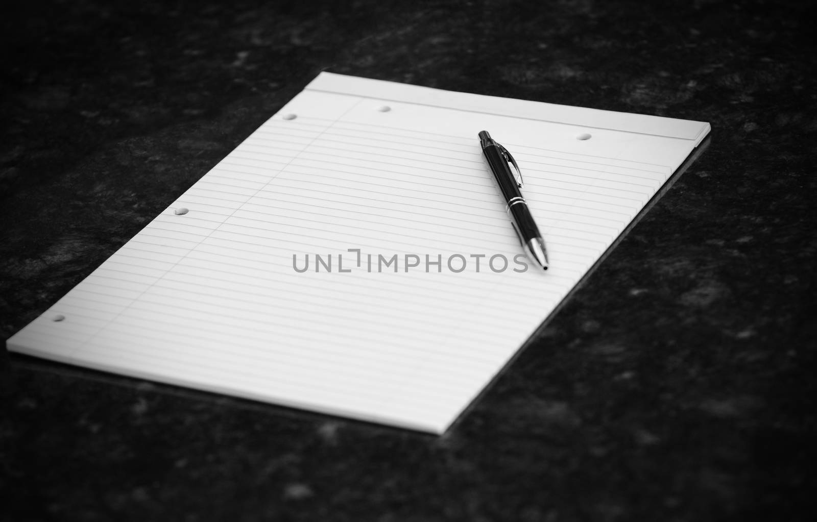 blank notebook with pen on desk