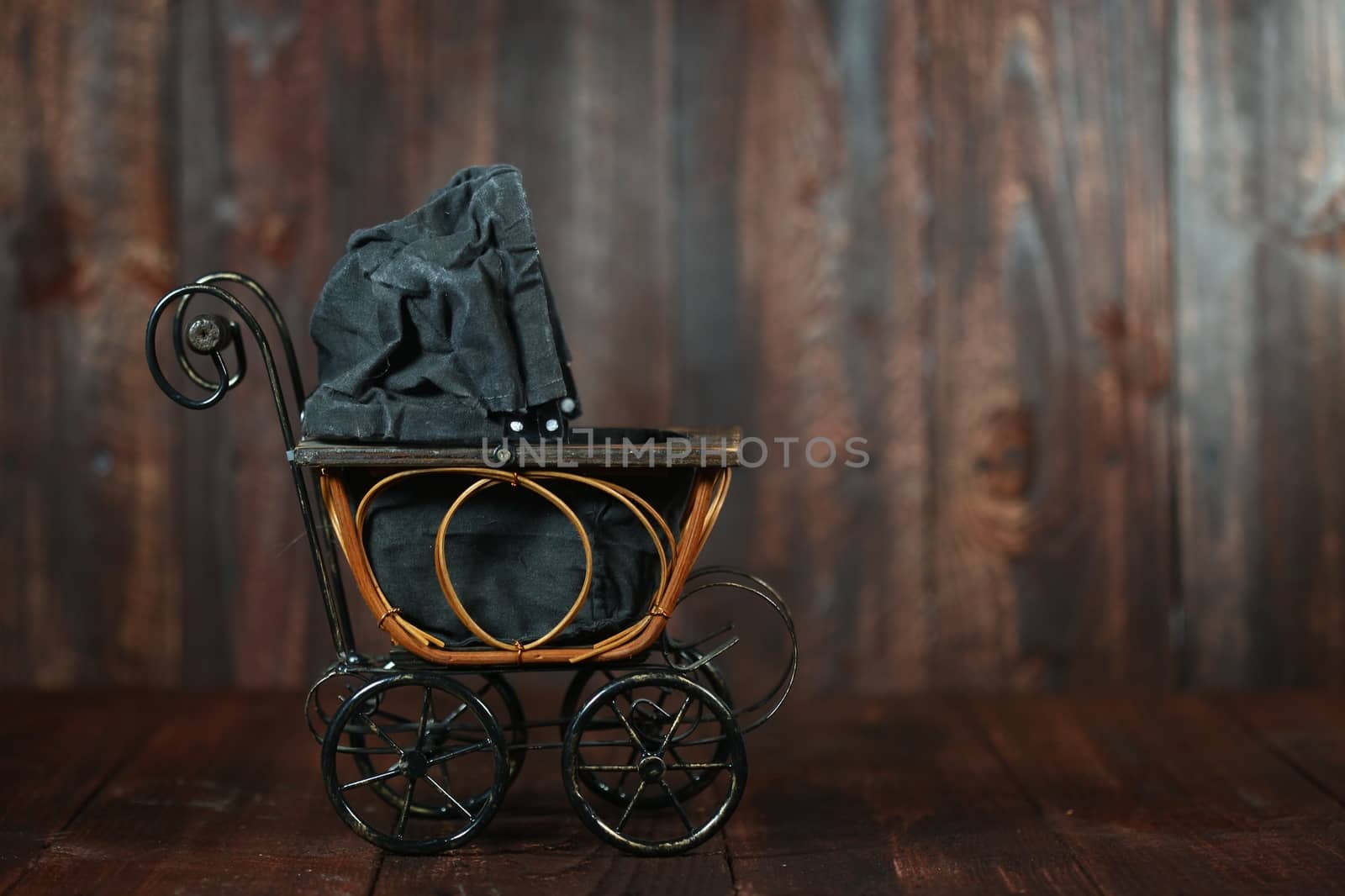 Antique Infant Baby Cradle on Grunge Wooden Background