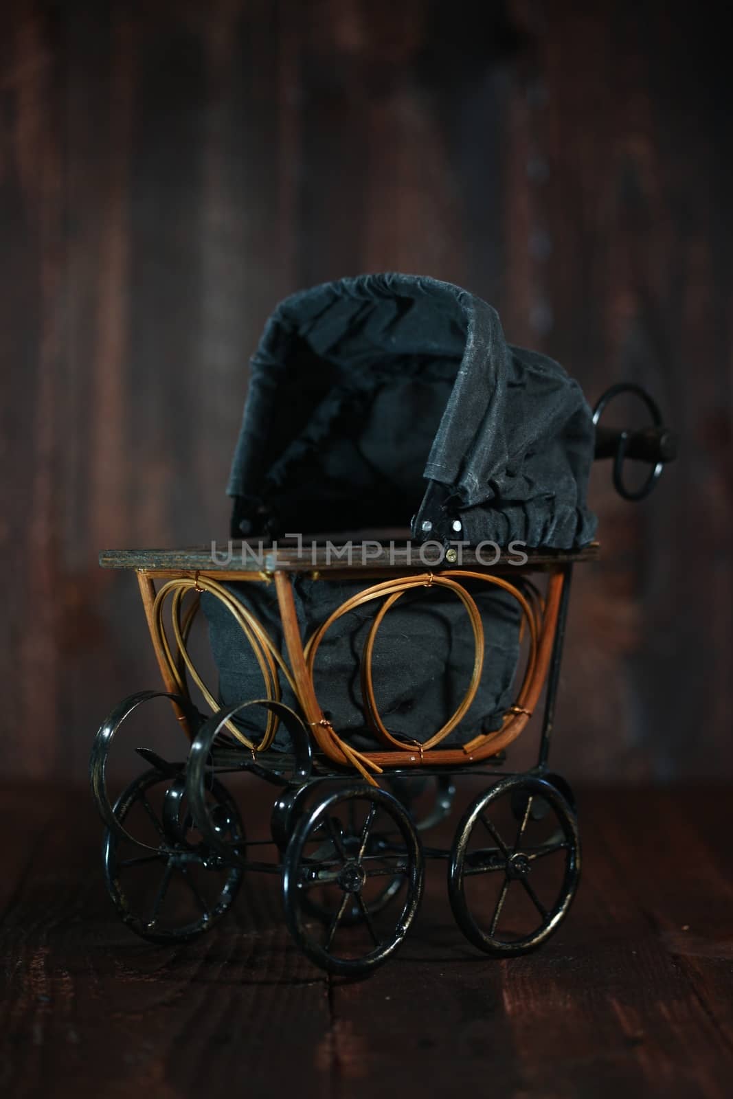 Baby Cradle on Grunge Wooden Background by tobkatrina