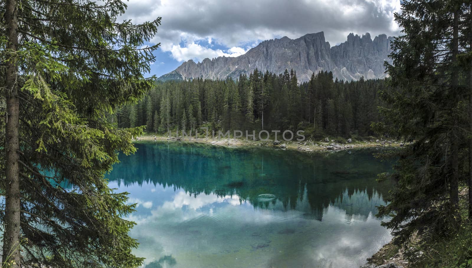 Carezza lake and Latemar in summer season with clouds, Dolomites - Italy