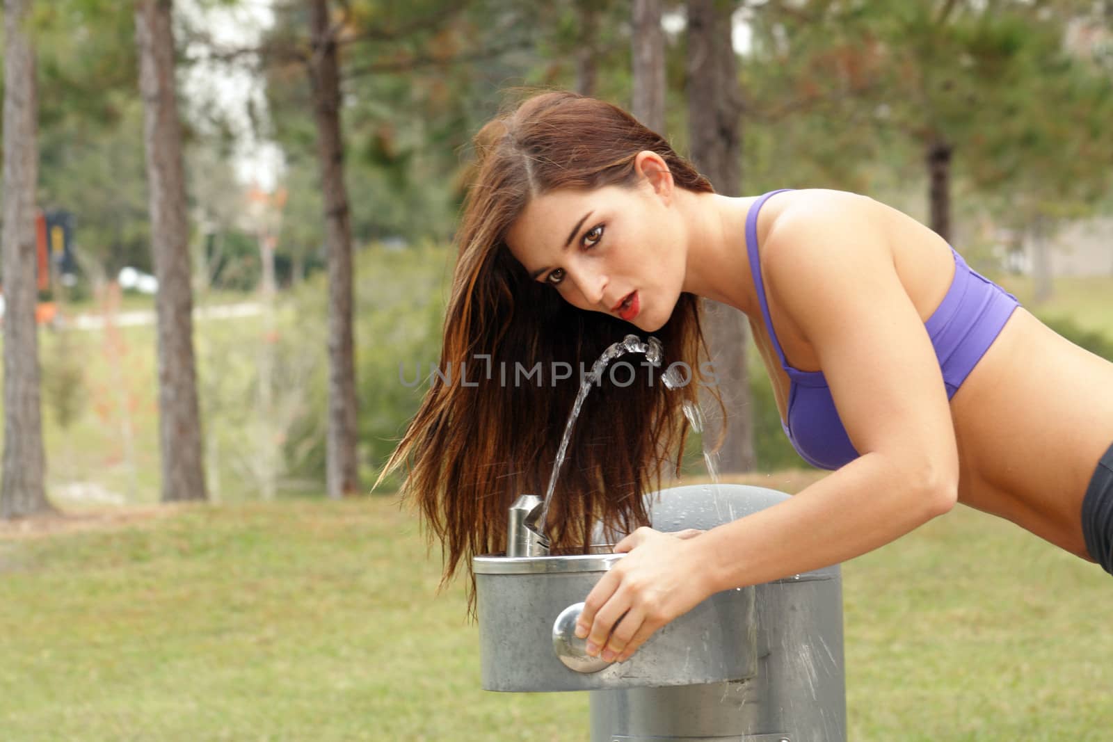 Beautiful Brunette Athlete at a Water Fountain (1) by csproductions