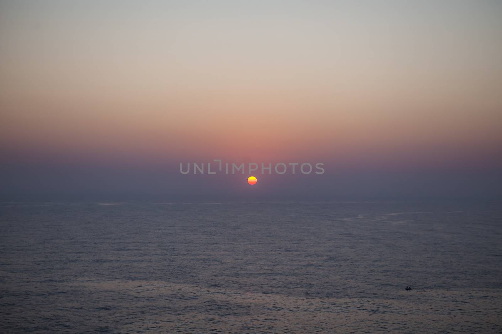 The sun rises over the calm waters of the Mediterranean Sea in Malta