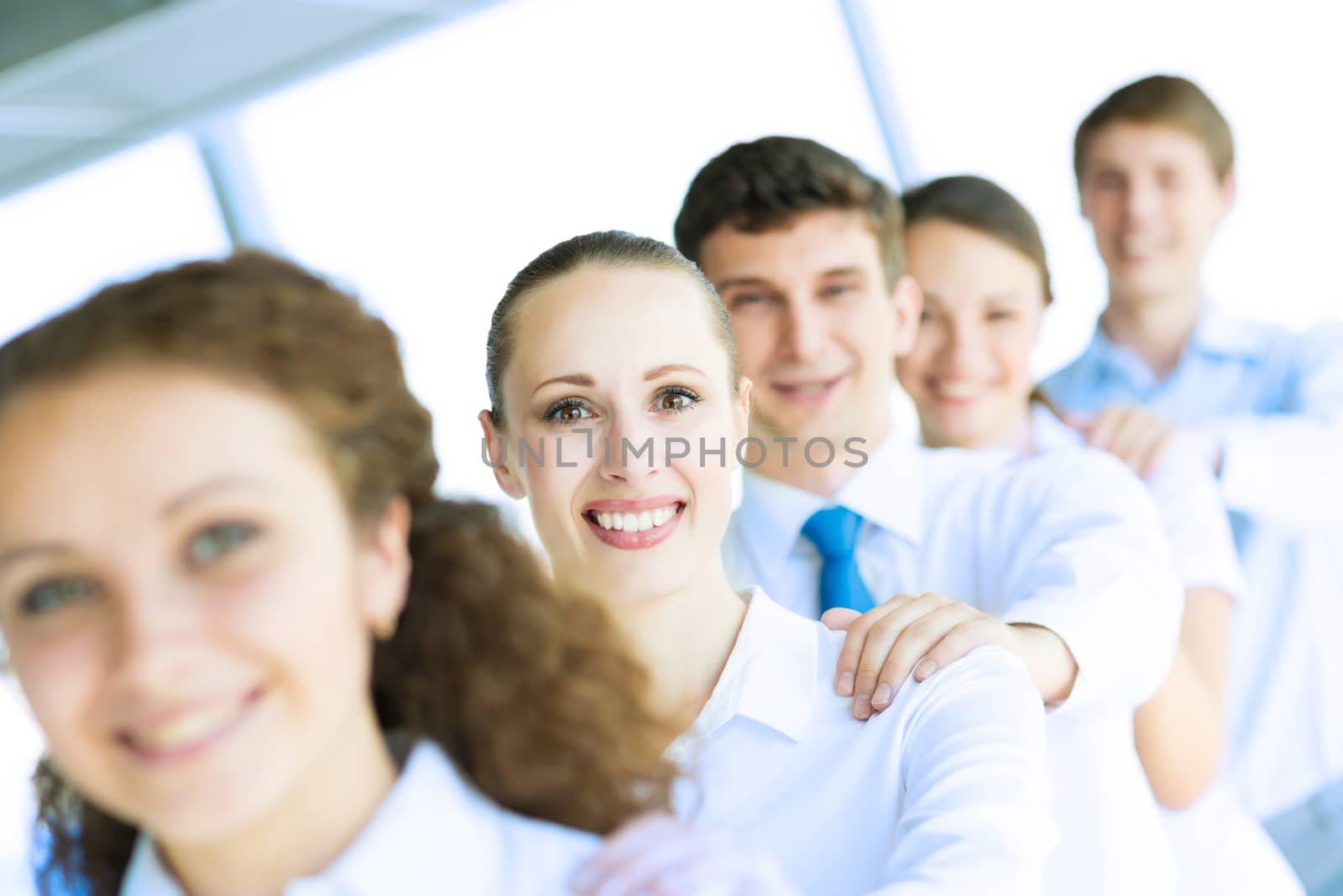 portrait of a young business woman standing in line with colleagues, concept of teamwork