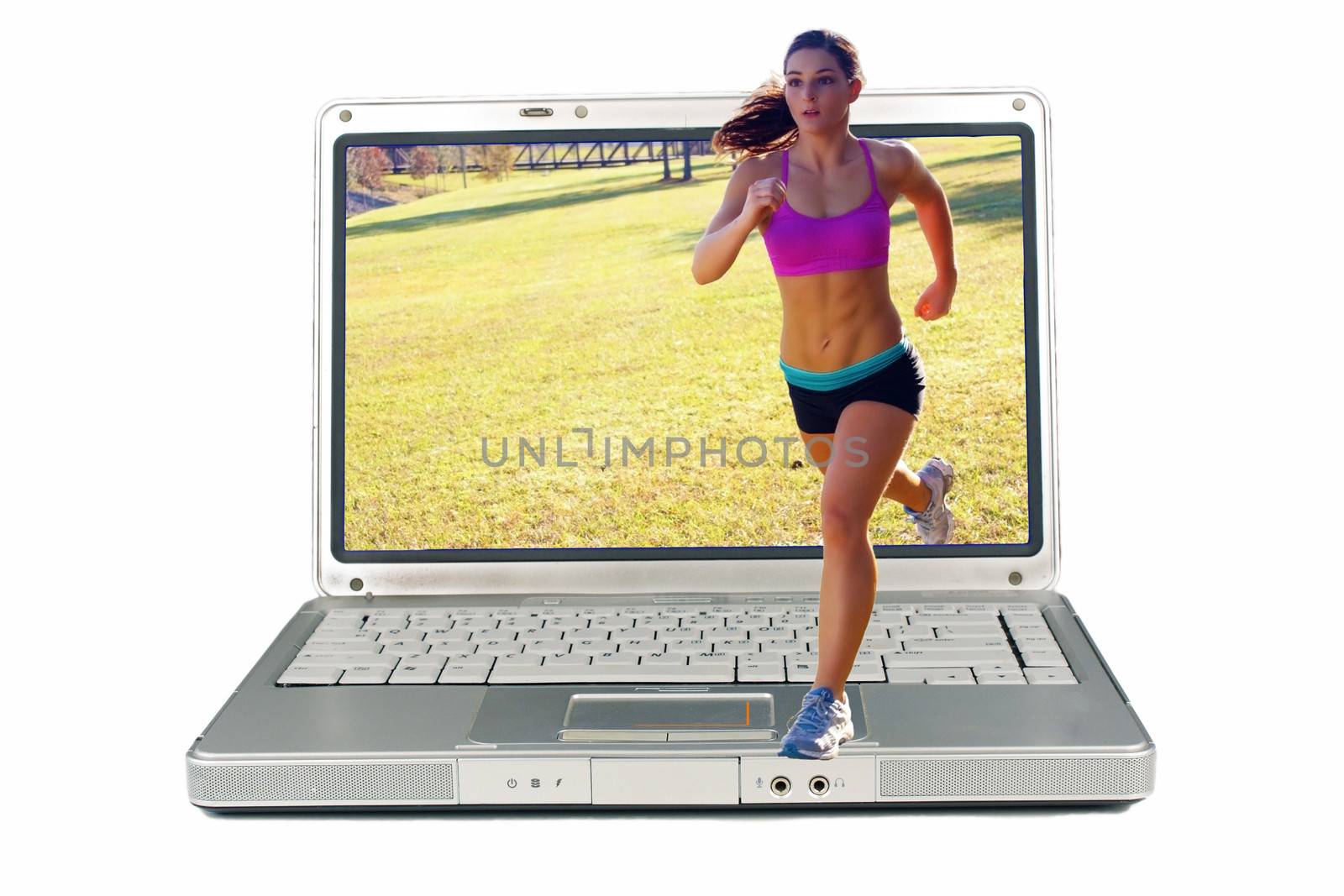 A lovely young athlete with remarkable abdominal musculature jogging outdoors and out of a laptop computer screen.  Generous copyspace.