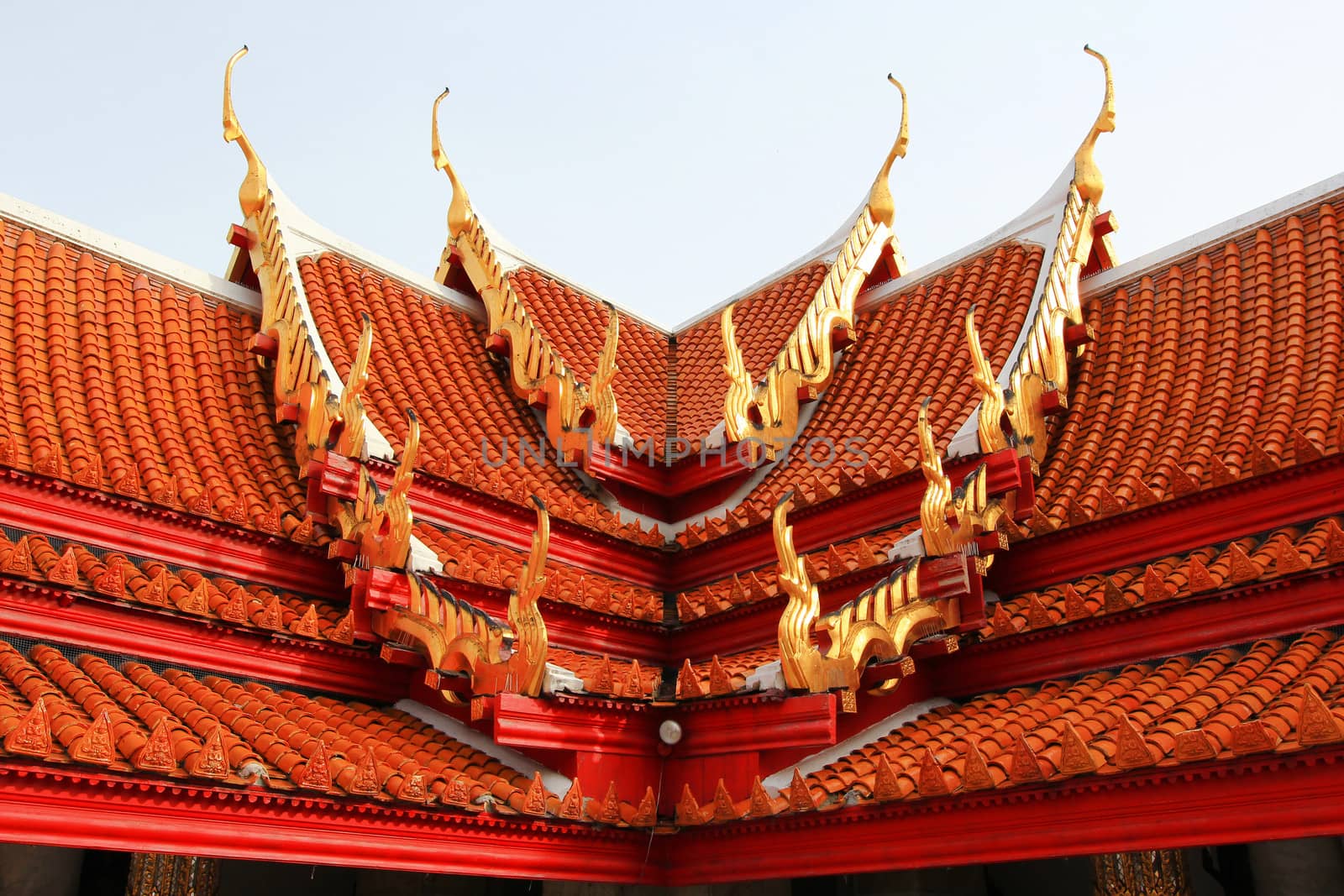 Multi layered roof with the figure of deity holding two palms to perform veneration's glazed tile