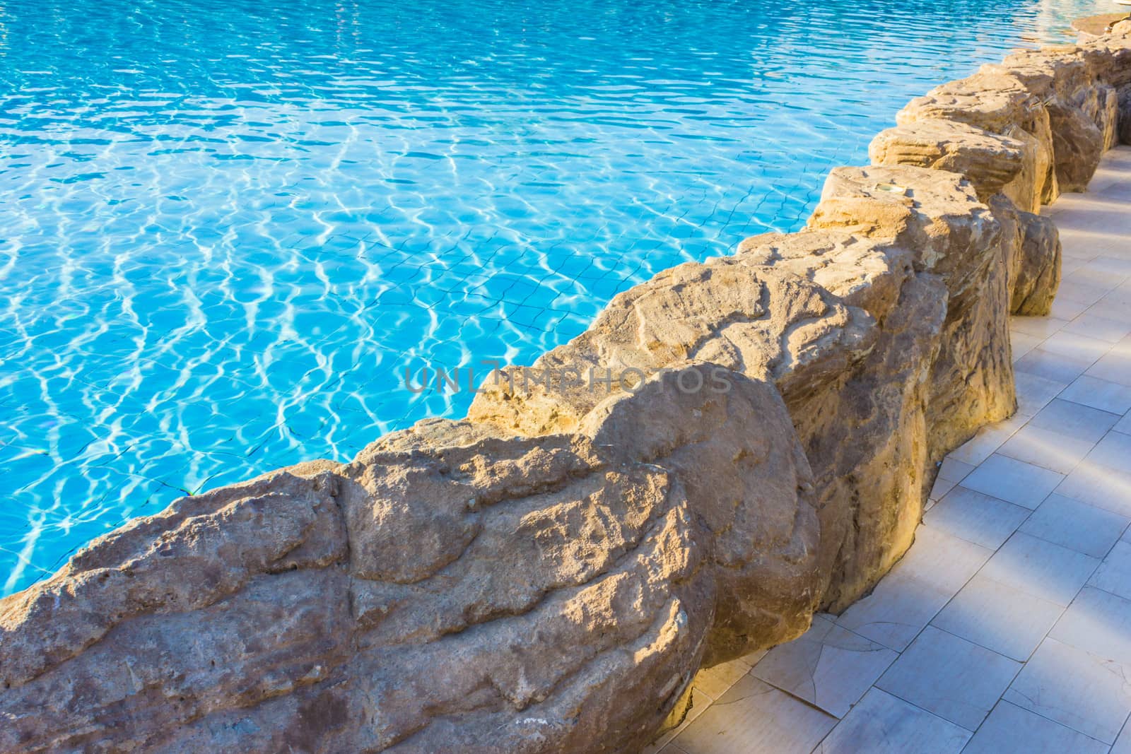 side of pool is edged with stone by oleg_zhukov