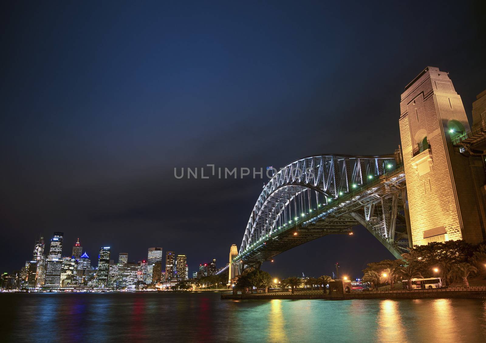 harbour bridge and skyline of sydney australia at night by jackmalipan