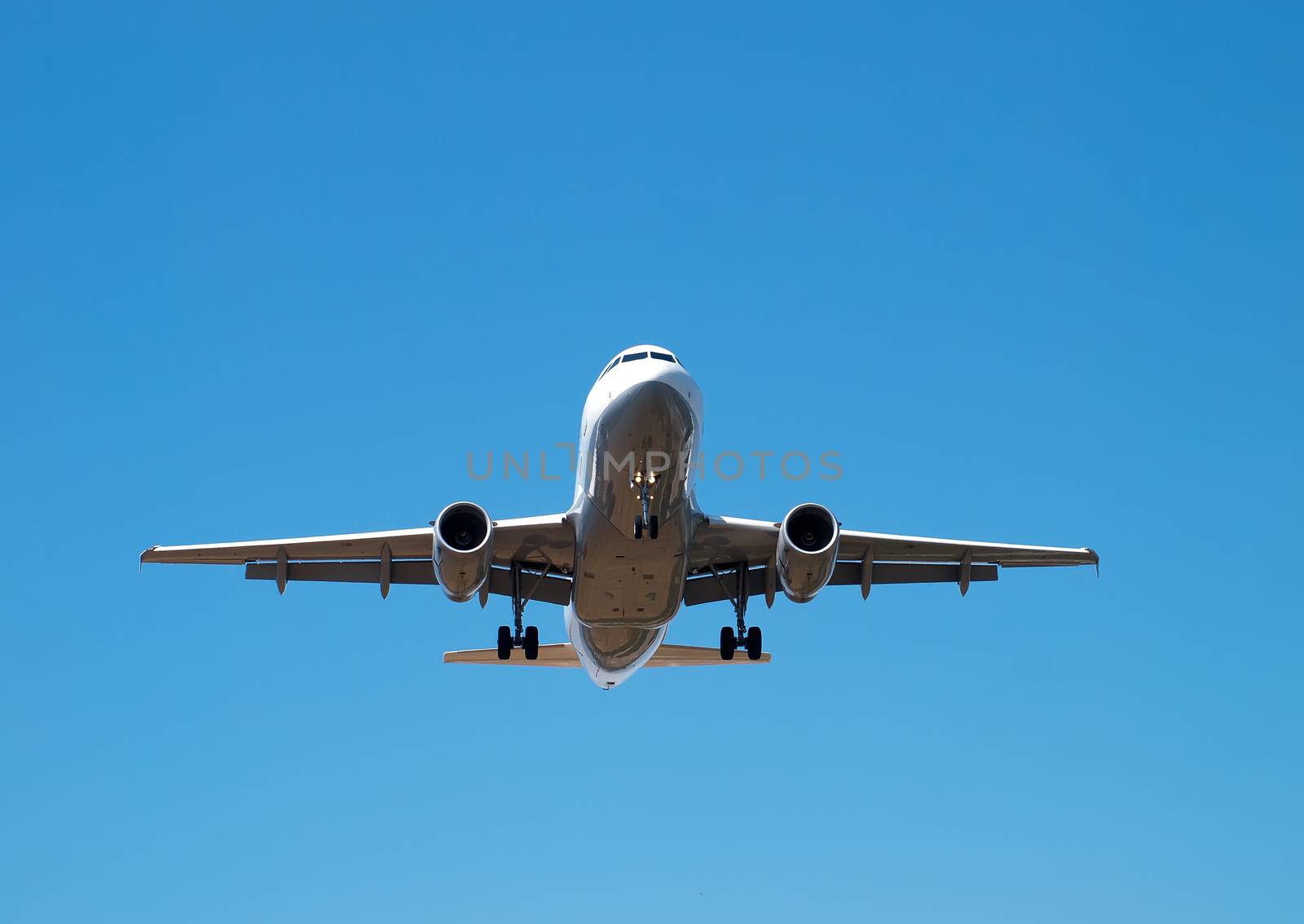 airplane landing on clear sunny day