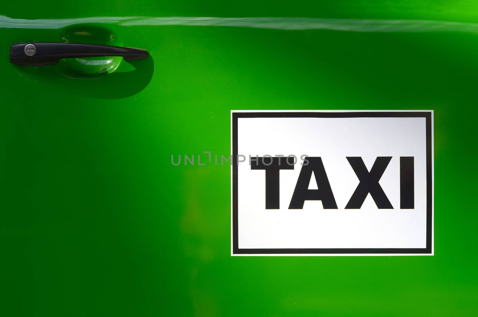 Sign On The Door Of A Bright Green Taxi