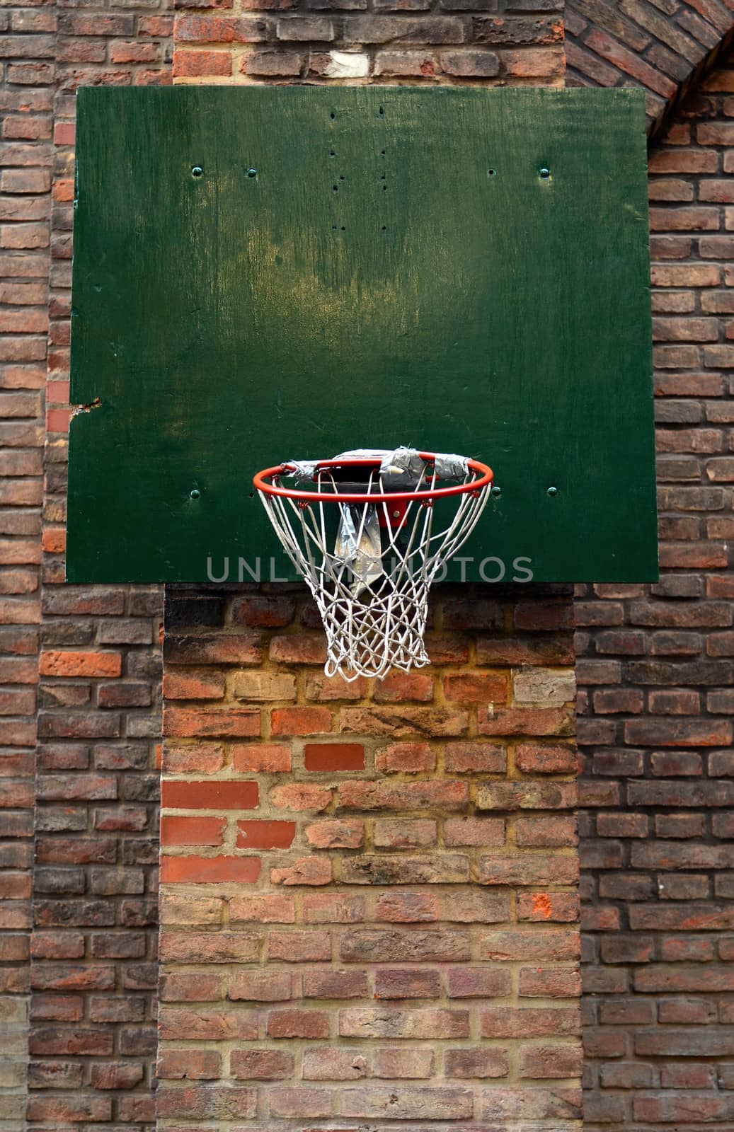 Grungy, Damaged Urban Basketball Net Against Brick Wall