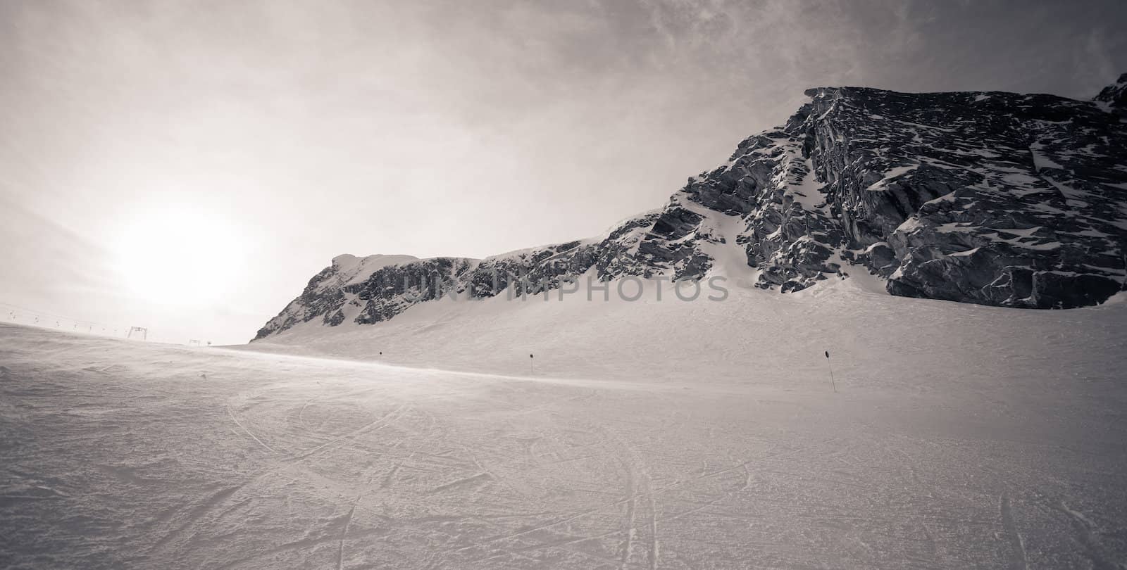 winter with ski slopes of kaprun resort next to kitzsteinhorn peak in austrian alps