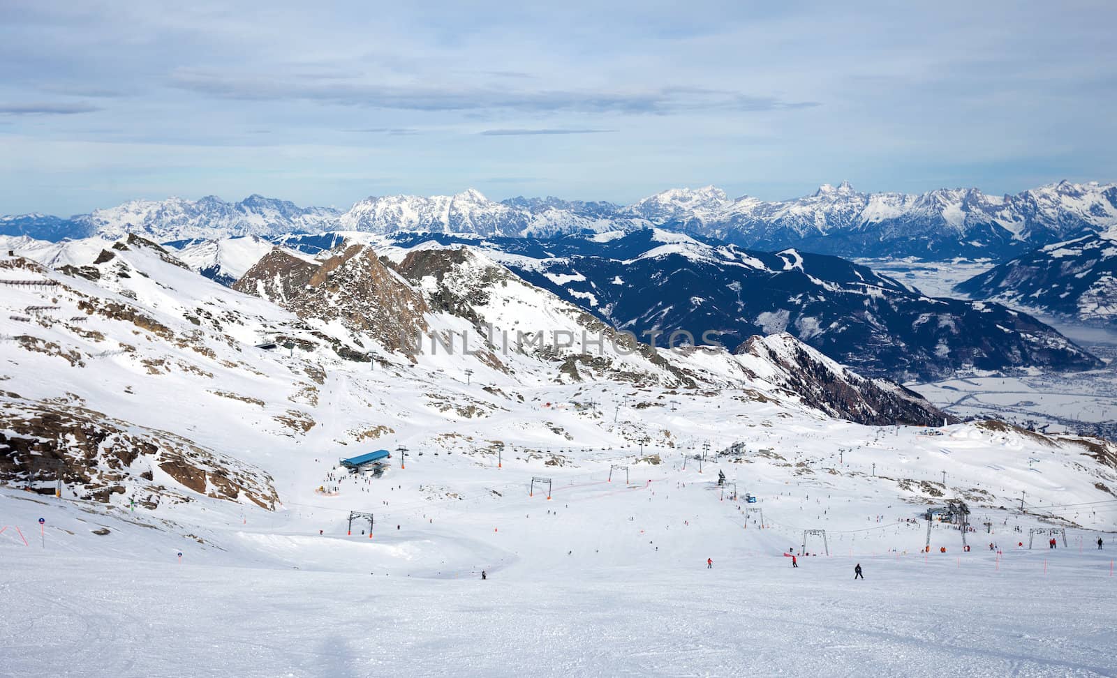 winter with ski slopes of kaprun resort next to kitzsteinhorn peak in austrian alps