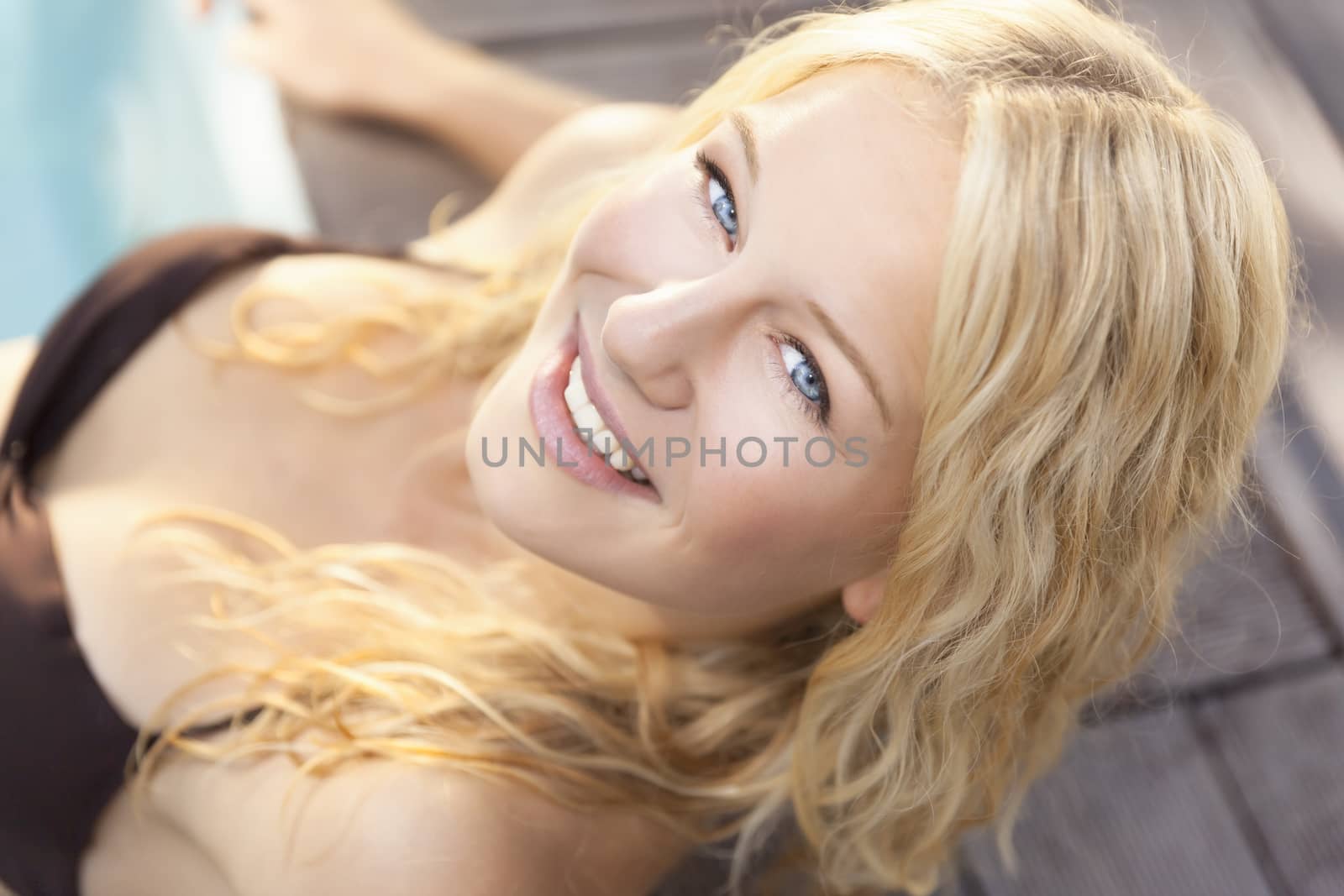 A beautiful blonde woman in the blue pool