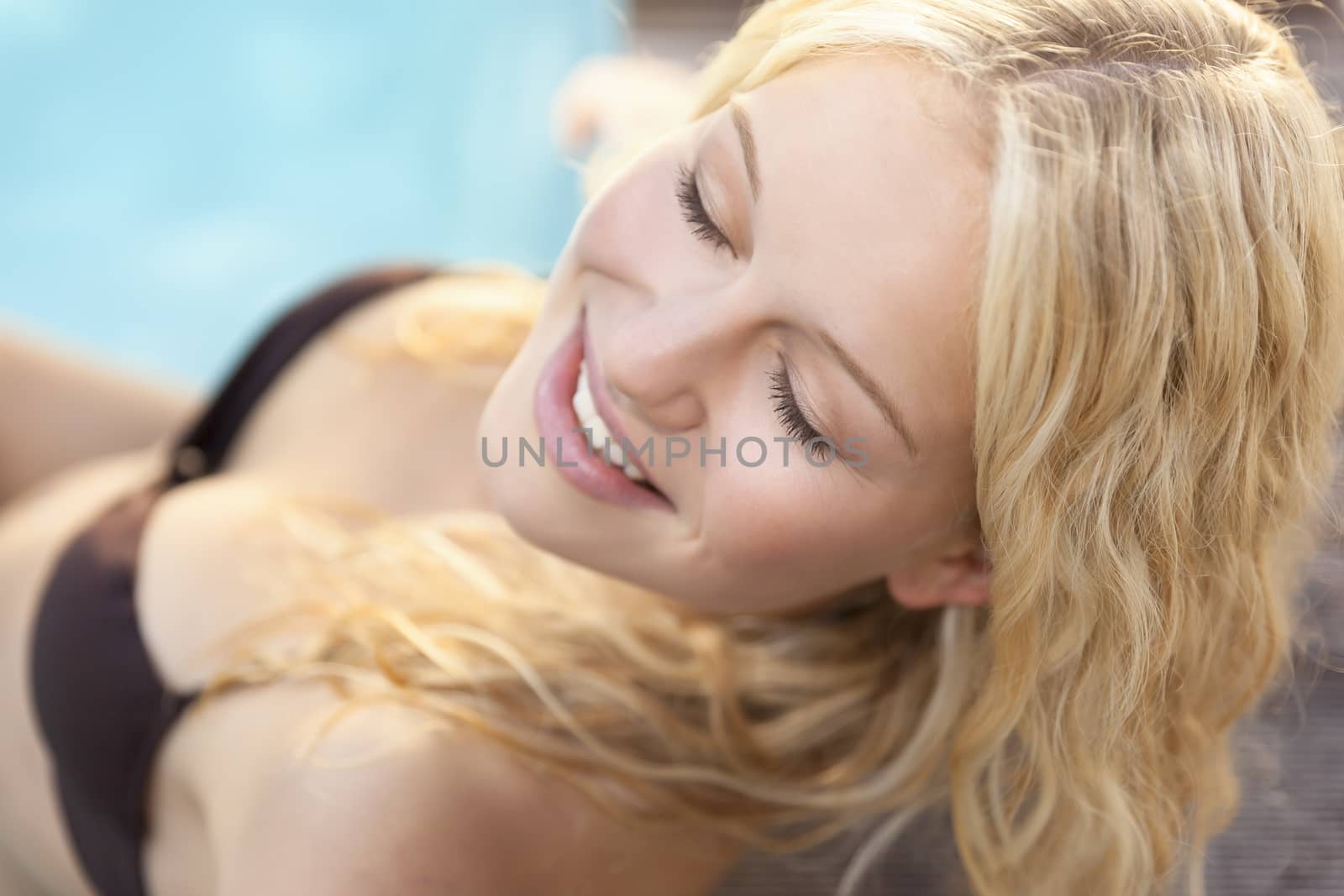 A beautiful blonde woman in the blue pool