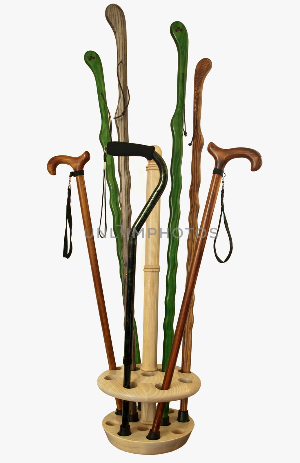 assorted canes and walking sticks in a wooden holder