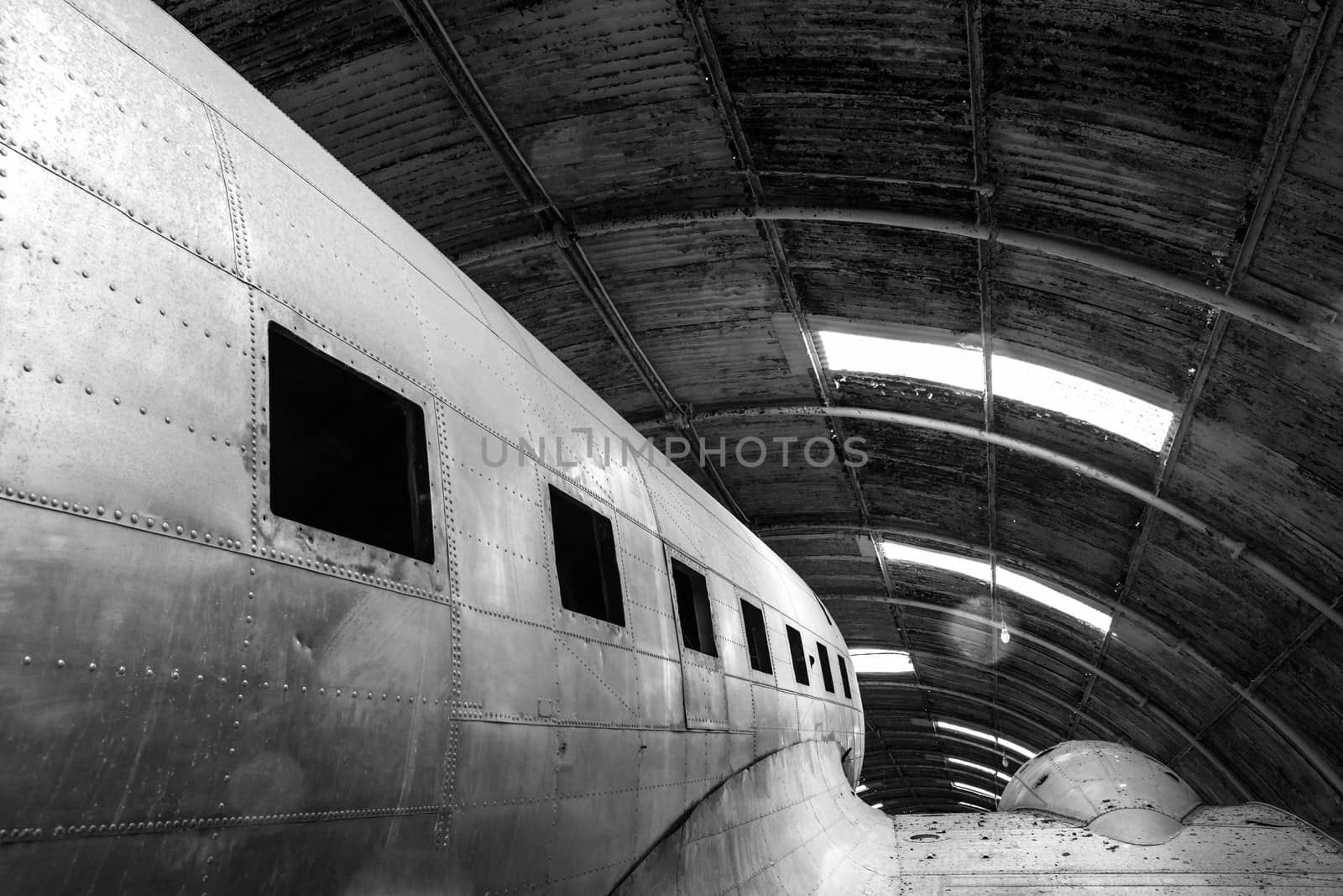 Abstract detail monochrome shot of a disused old aircraft in a hangar