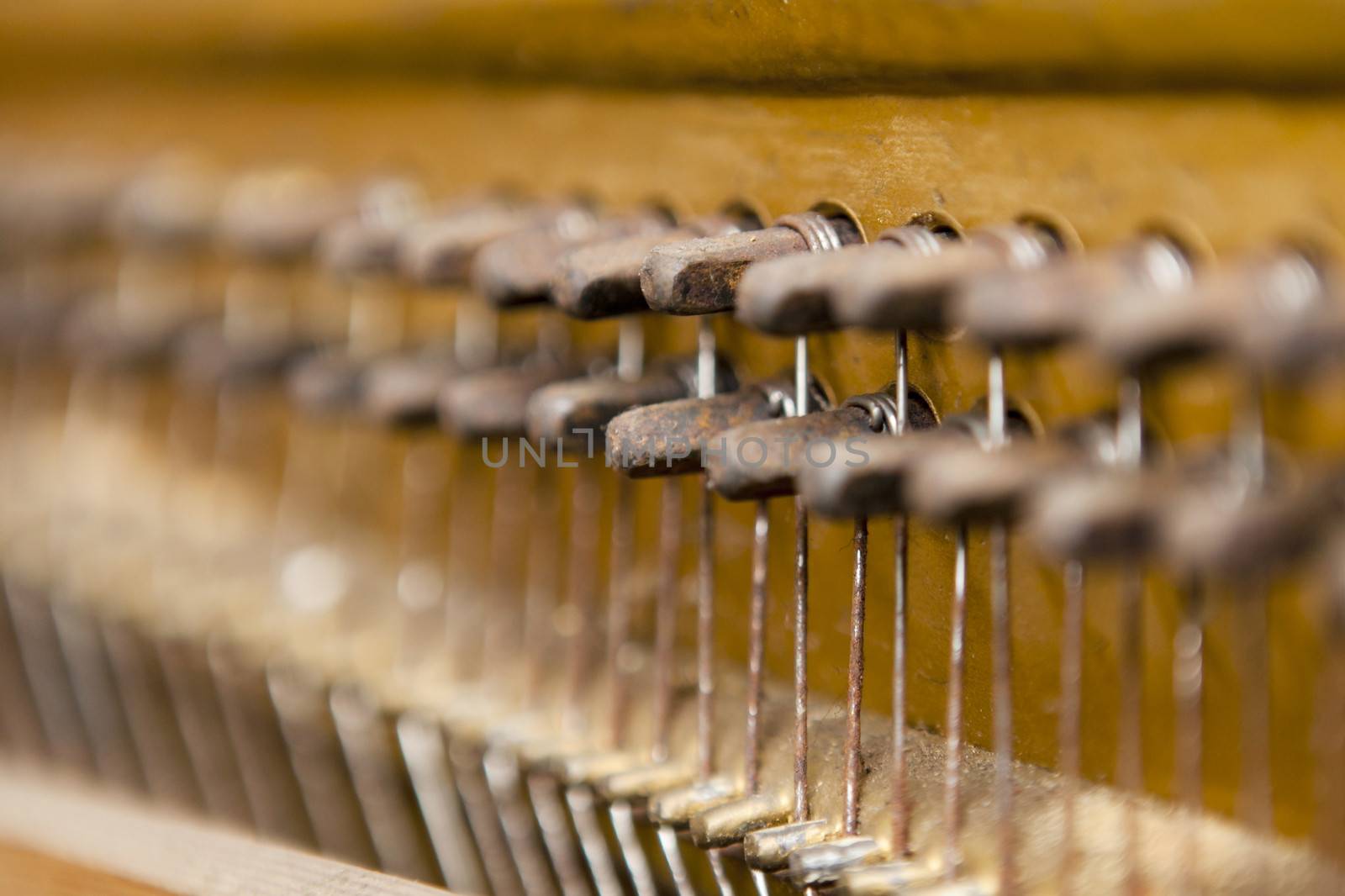 Detail shot of an old piano's hammers and inside works
