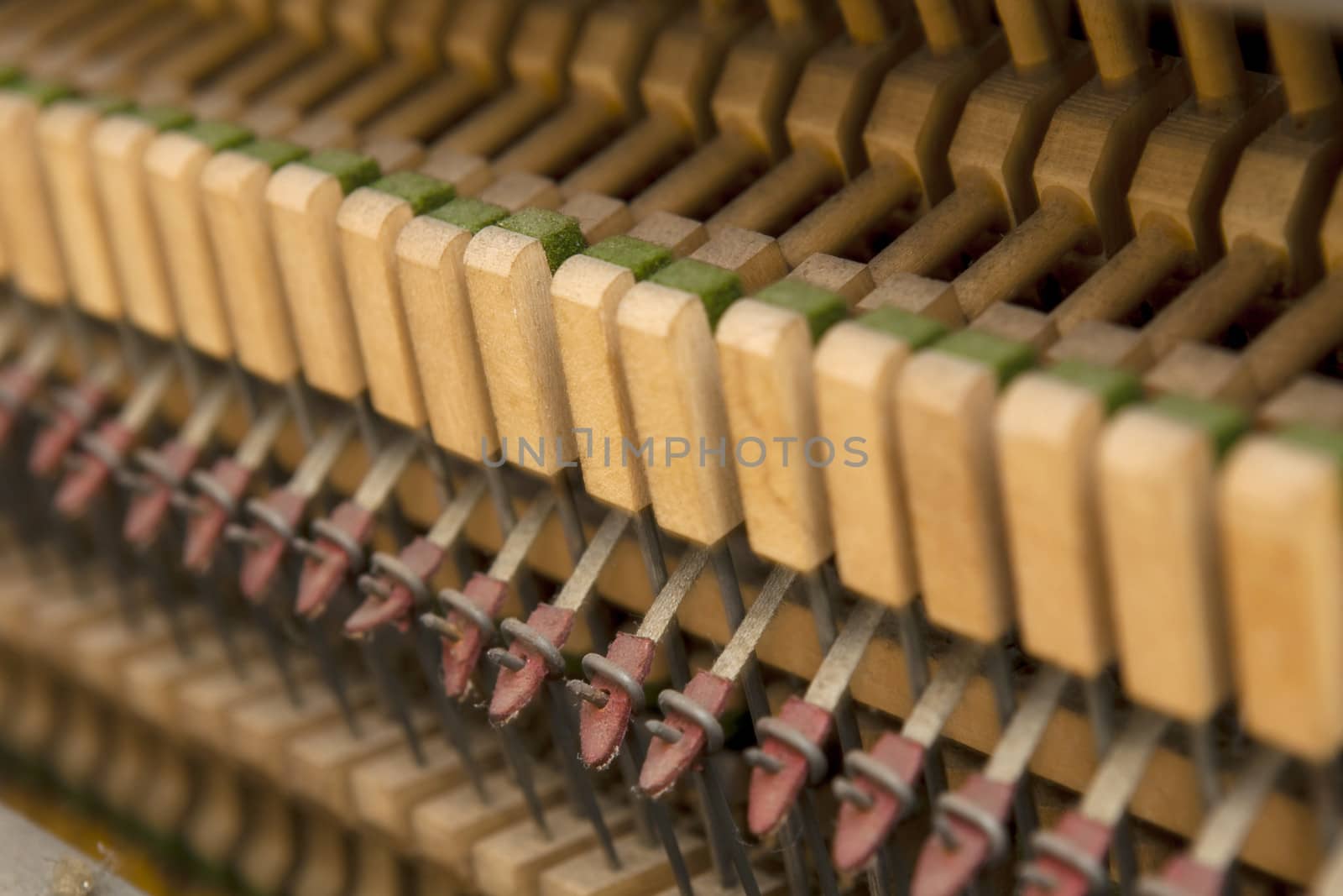 Detail shot of an old piano's hammers and inside works